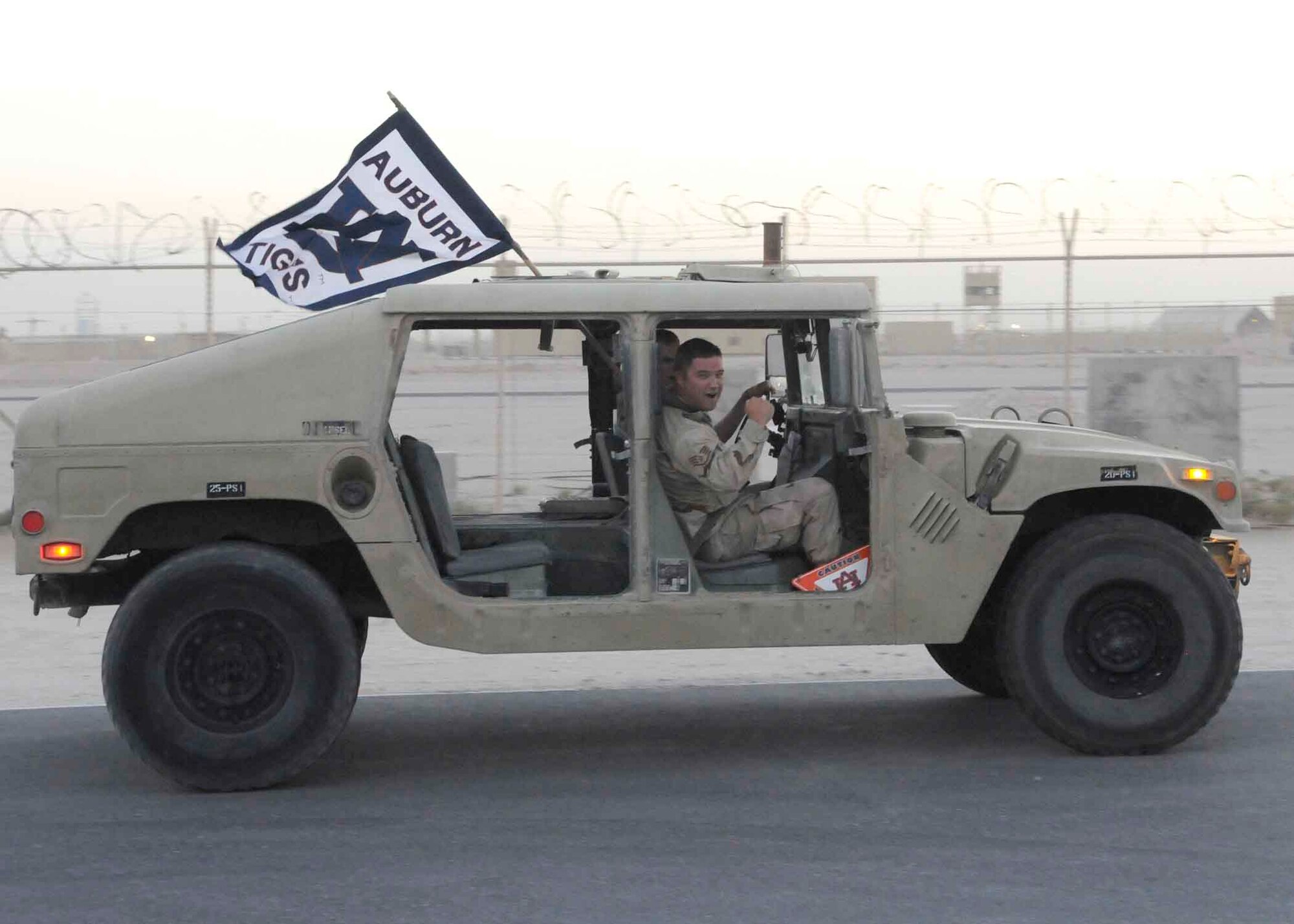 SOUTHWEST ASIA -- Staff Sgt. Noah Mckenzie, 379th Expeditionary Civil Engineer Squadron readiness and emergency management technician, shows his support for the Auburn University Tigers during the NCAA coaches tour here May 22. He is from Daphne, Ala., deployed here from Patrick Air Force Base, Fla. (U.S. AIR FORCE PHOTO BY TECH. SGT. JOHNNY SALDIVAR)