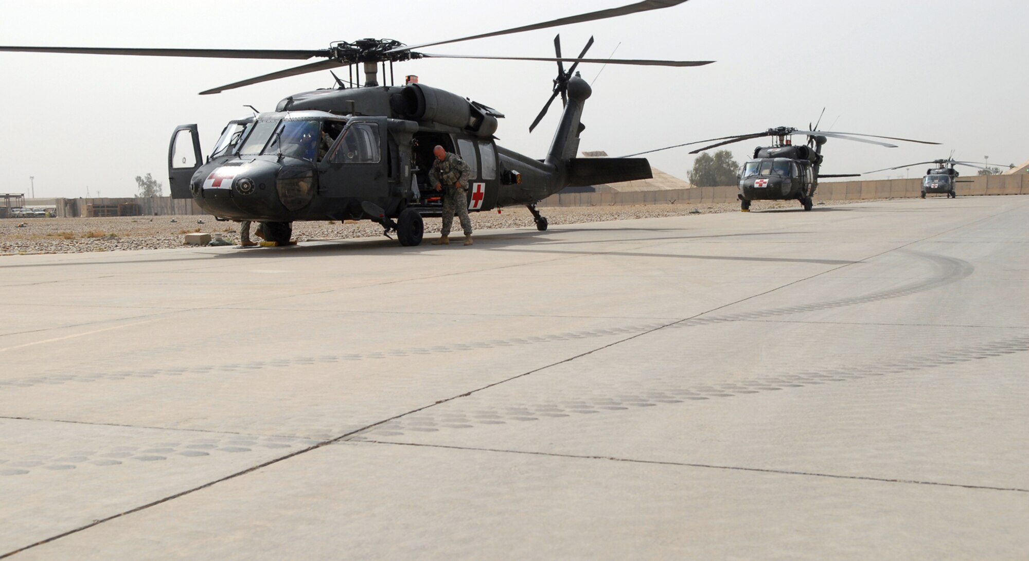 BALAD AIR BASE, Iraq -- Soldiers assigned to the 7th Battalion, 101st Aviation Regiment gear up before responding to a medical evacuation call here, May 5. The two, four-member crews are airborne to pick up patients, on average, within seven minutes of getting a medevac call. Critically injured servicemembers and civilians are often brought to the Air Force Theater Hospital here for treatment. The 7th Battalion, 101st Aviation Regiment is deployed from Fort Campbell, Ky. (U.S. Air Force photo/ Senior Airman Julianne Showalter)