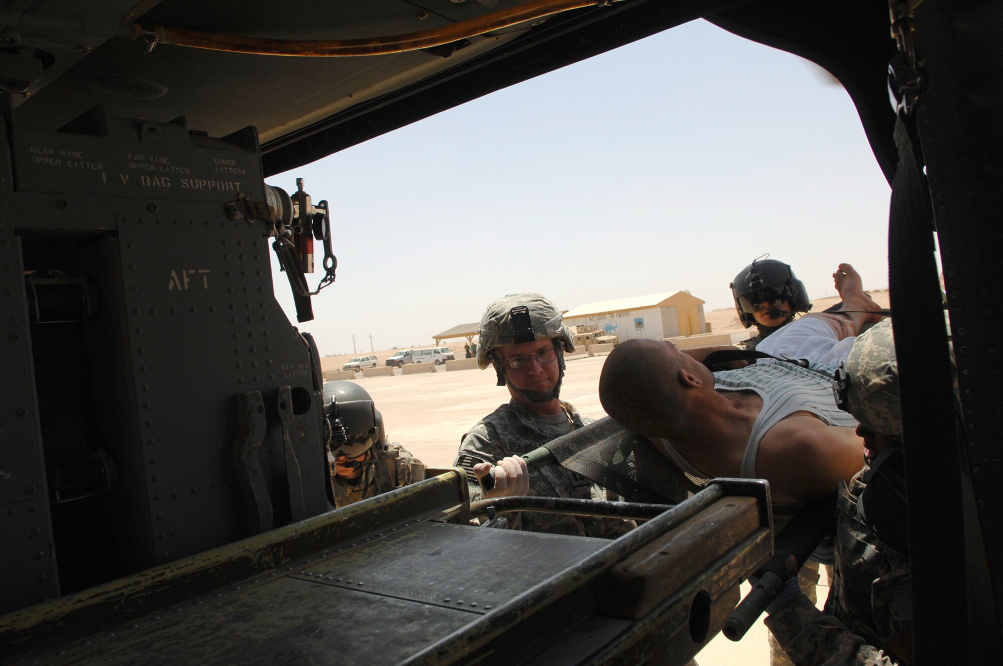 BALAD AIR BASE, Iraq -- U.S. Soldiers assigned to Camp Grizzly help load a trauma patient onto a Blackhawk helicopter here, May 20. The transfer of patients to a higher echelon of care within one hour of being injured is a critical link in the chain of events to ensure patients in Iraq are given the best chance for survival. Critically injured servicemembers and civilians are often brought to the Air Force Theater Hospital at Balad AB for treatment. (U.S. Air Force photo/ Senior Airman Julianne Showalter)