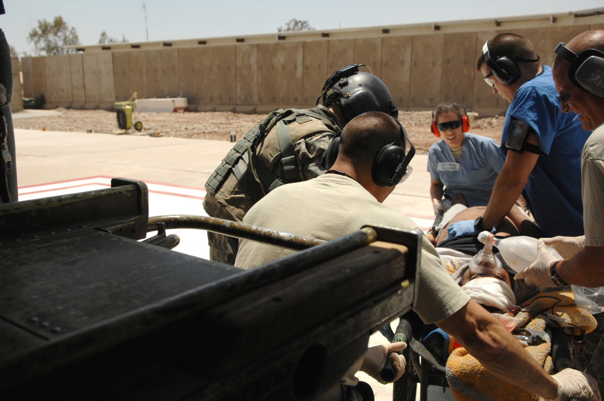 BALAD AIR BASE, Iraq -- Members from the 332nd Expeditionary Medical Group help download a trauma patient form an U.S. Army Blackhawk helicopter before taking him into the Air Force Theater Hospital emergency room for further treatment here, May 20. U.S. Army medical evacuation crews, from 7th Battalion, 101st Aviation Regiment assigned to Balad Air Base, are a critical link in the chain of events to ensure patients in Iraq are transported to the next echelon of care within one hour of being injured. (U.S. Air Force photo/ Senior Airman Julianne Showalter)