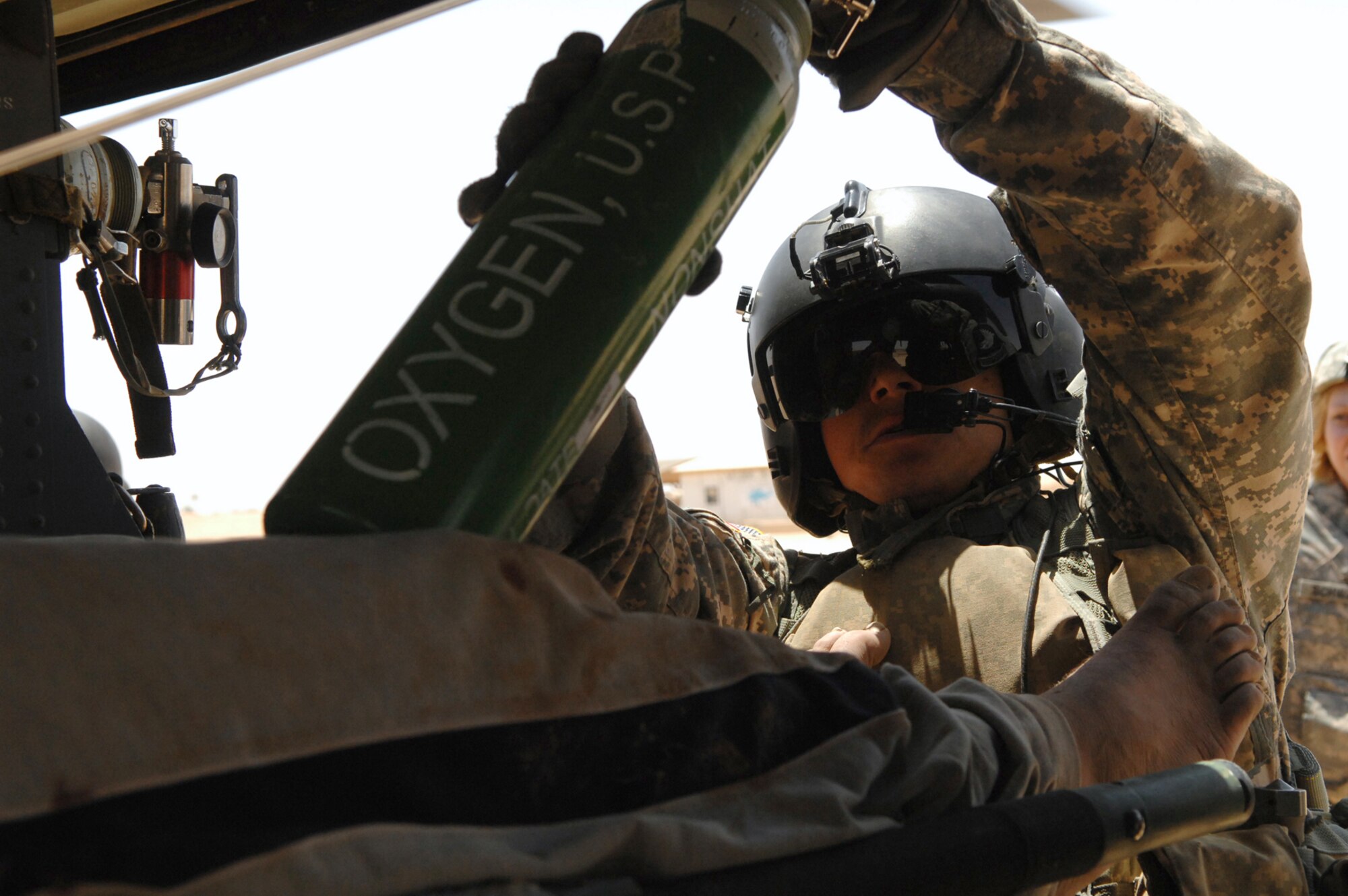 BALAD AIR BASE, Iraq -- Army Staff Sgt. Anthony Cox, a 7th Battalion, 101st Aviation Regiment flight medic, loads up an oxygen tank before take off from Camp Grizzly to the Air Force Theater Hospital here, May 20. U.S. Army medical evacuation crews, from the 7th Battalion, 101st Aviation Regiment assigned to Balad Air Base, are a critical link in the chain of events patients in Iraq are transported to the next echelon of care within one hour of being injured. Sergeant Cox is deployed from Fort Campbell, Ky. (U.S. Air Force photo/ Senior Airman Julianne Showalter)