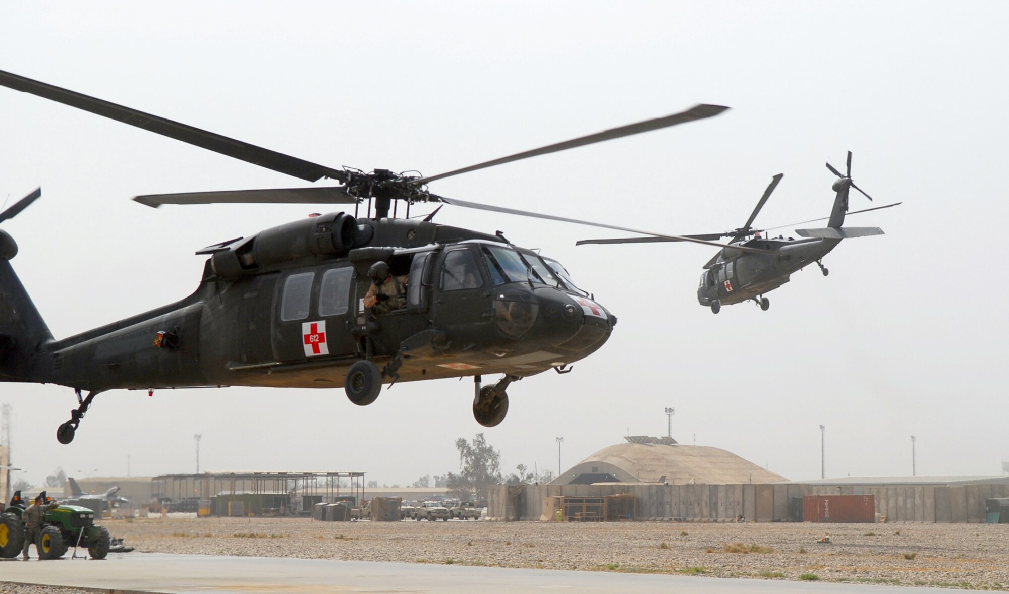 BALAD AIR BASE, Iraq -- A pair of Army Blackhawk helicopters take off to respond to a medical evacuation call here, May 5. The two, four-member crews consist of a pilot, co-pilot, flight medic and crew chief. The medevac crews are a critical link in the chain of events to ensure patients in Iraq are transported to the next echelon of care within one hour of being injured. Critically injured servicemembers and civilians are often brought to the Air Force Theater Hospital at Balad AB for treatment. (U.S. Air Force photo/ Senior Airman Julianne Showalter)