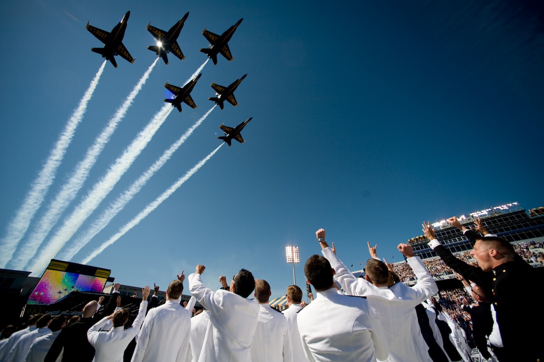 Graduates at the U.S. Naval Academy cheer as the Navy's Blue Angels fly