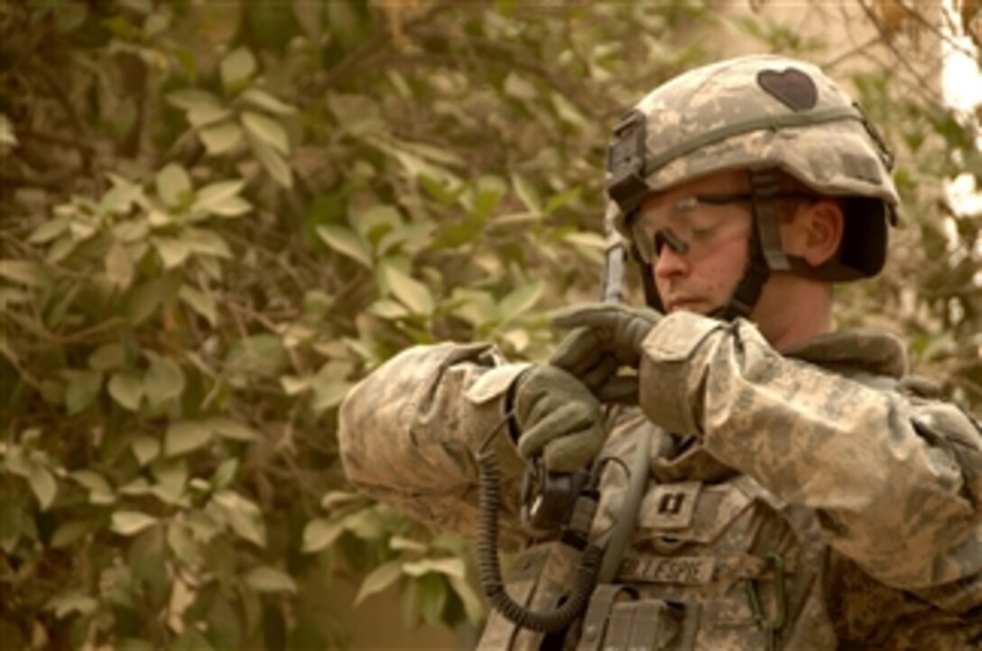 A U.S. Army soldier checks his watch for the accurate time of a mortar attack he observed while searching for weapons caches in northwest Shulla, Iraq, on May 16, 2008.  The soldiers are assigned to Bravo Troop, 1st Squadron, 75th Cavalry Regiment, 2nd Brigade Combat Team, 101st Airborne Division.  