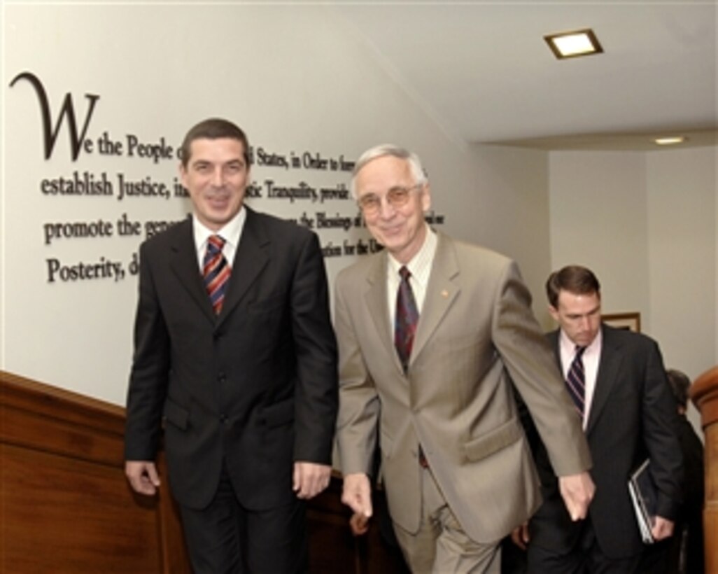 Deputy Secretary of Defense Gordon England (right) escorts Albanian Minister of Defense Gazmend Oketa to his Pentagon office where they will hold bilateral security talks on a variety of regional issues of interest to both nations on May 22, 2008.  