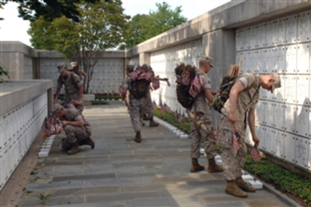 U.S. Marines place flags in the center of Arlington National Cemetery's columbarium during the "Flags In" Tribute to honor America's fallen heroes, May 22, 2008. The Marines, who recently returned from Iraq, are assigned to Marine Barracks Washington, D.C.