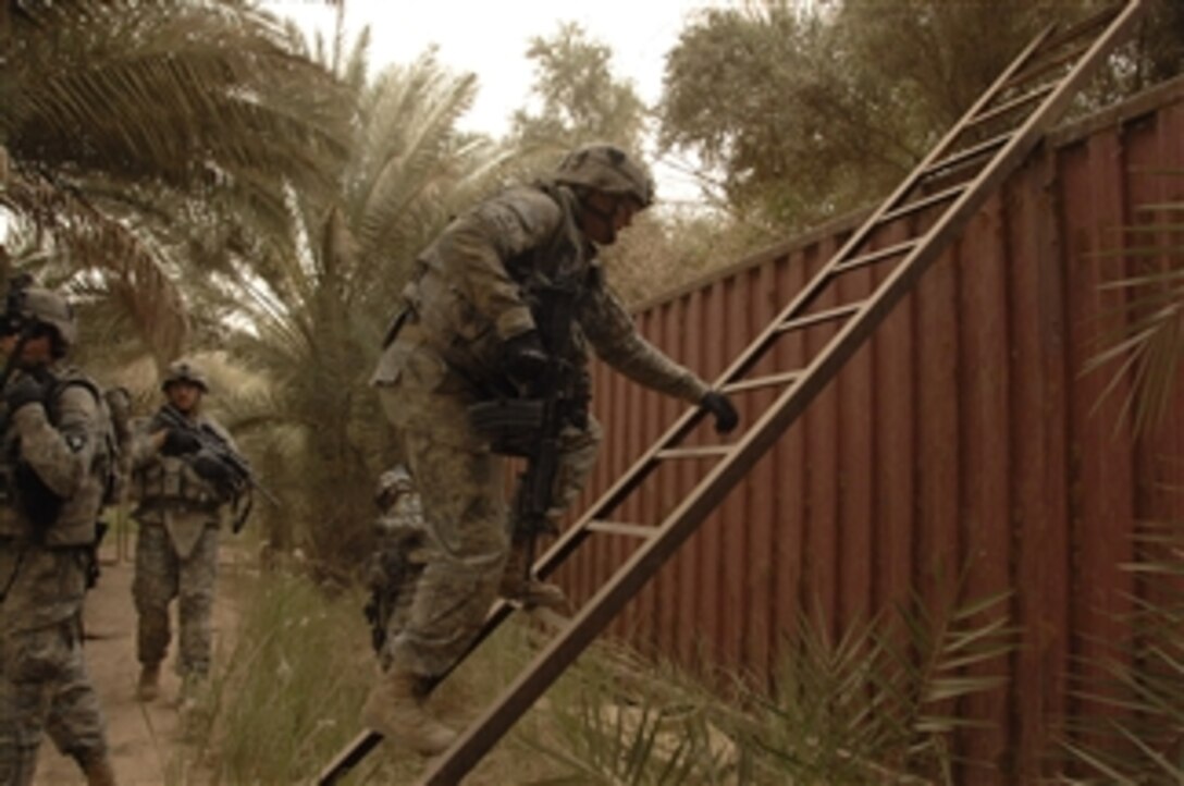 A U.S. Army soldier climbs a ladder to search for weapons caches in northwest Shulla, Iraq, on May 16, 2008.  The soldiers are assigned to Bravo Troop, 1st Squadron, 75th Cavalry Regiment, 2nd Brigade Combat Team, 101st Airborne Division.  