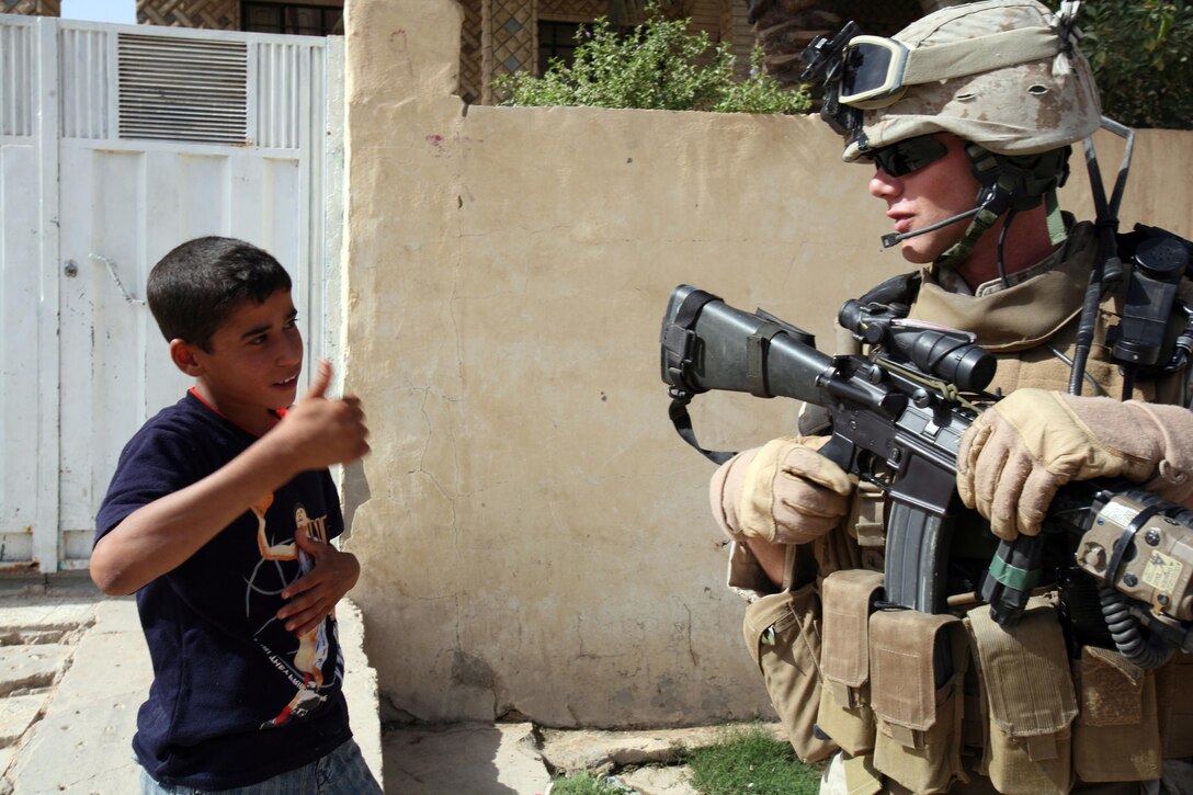 RAMADI, Iraq (July 4, 2008) Cpl. Chris Sarlo, a rifleman with Weapons Company, 1st Battalion, 9th Marine Regiment, Regimental Combat Team 1, receives a thumbs up from young citizen in Ramadi May 23. The city of Ramadi was once-considered the most violent city in Iraq. But now, the locals have revolted against al Qaeda and are cooperating with Coalition forces to weed out al Qaeda in the province. (Official U.S. Marine Corps photo by Lance Cpl. Casey Jones) (RELEASED)