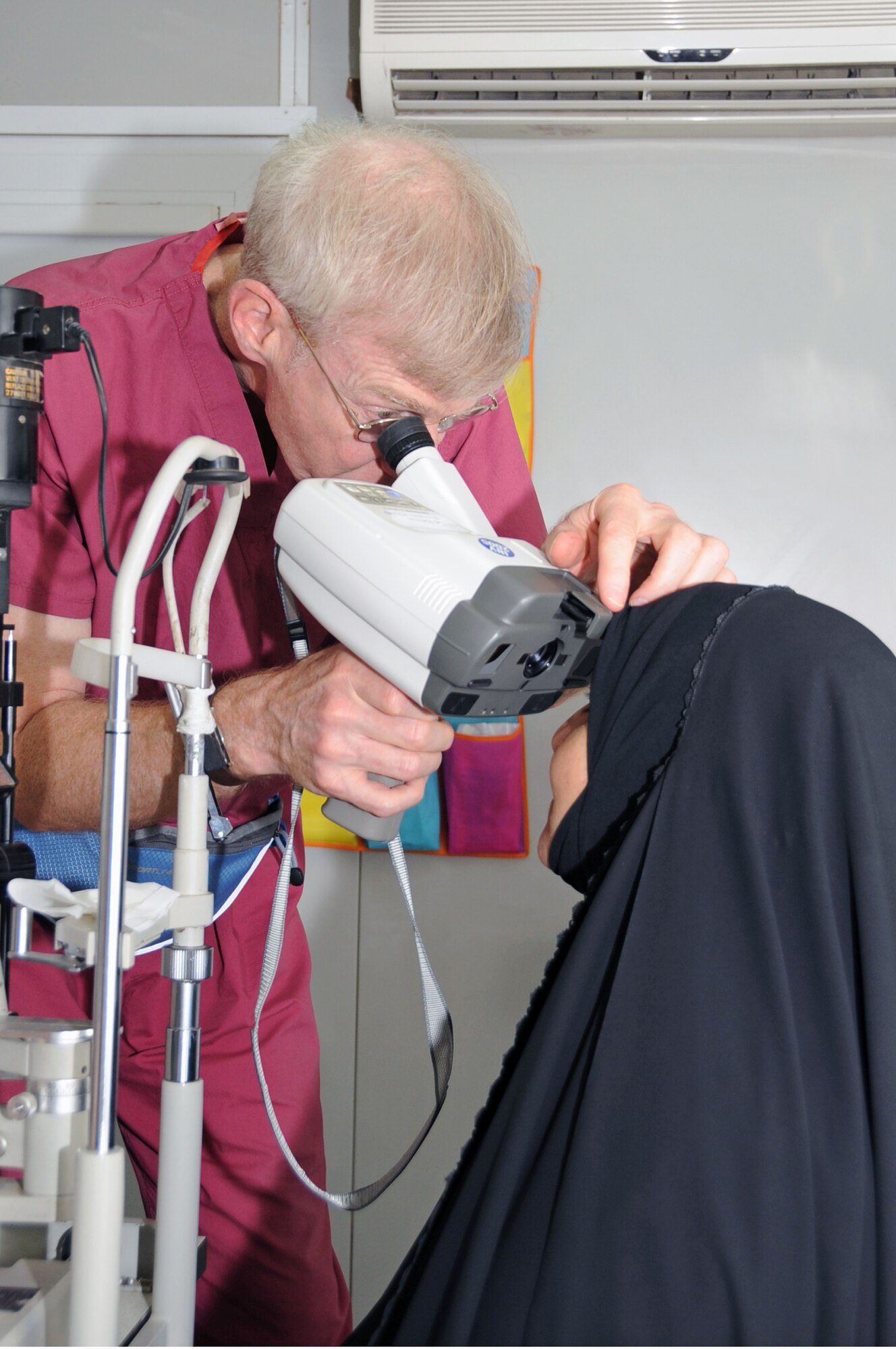 ALI BASE, Iraq -- Retired Air Force Colonel Stephen Waller, a contract ophthalmologist from Wilford Hall Medical Center, Lackland AFB, Texas, checks the prescription of an Iraqi woman here May 20. The doctor came to Iraq to provide eye exams, surgeries and free glasses to hundreds of Iraqis in need. Dr.  Waller arrived here May 18 and finished his humanitarian mission four days later. (U.S. Air Force photo/Tech. Sgt. Sabrina Johnson)