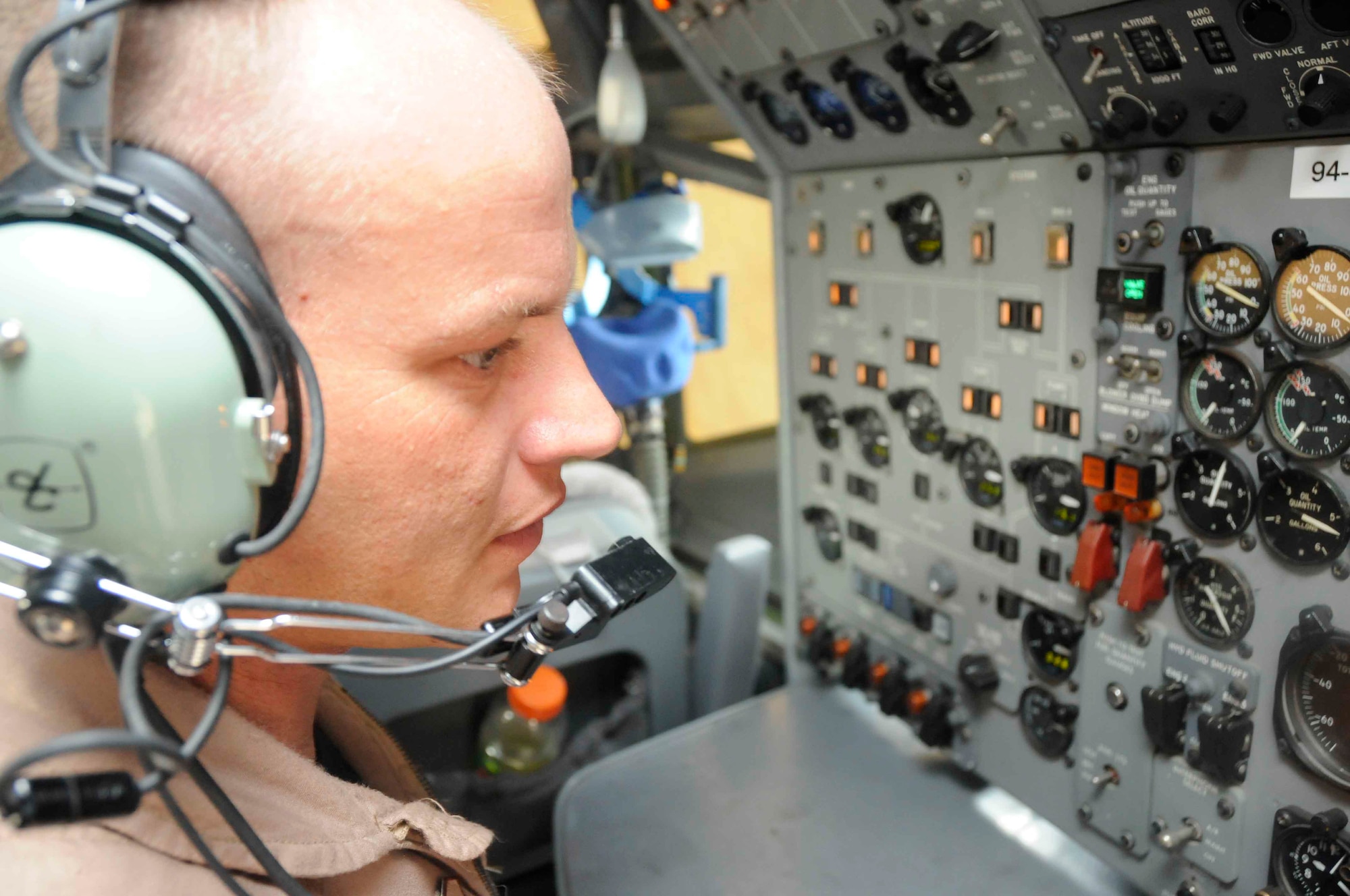 SOUTHWEST ASIA—Tech. Sgt. Mike Arnold, 7th Expeditionary Airborne Command and Control Squadron, performs pre-flight checks inside the cockpit of a modified Boeing 707 May 19. (U.S. Air Force photo/ Senior Airman Domonique Simmons)