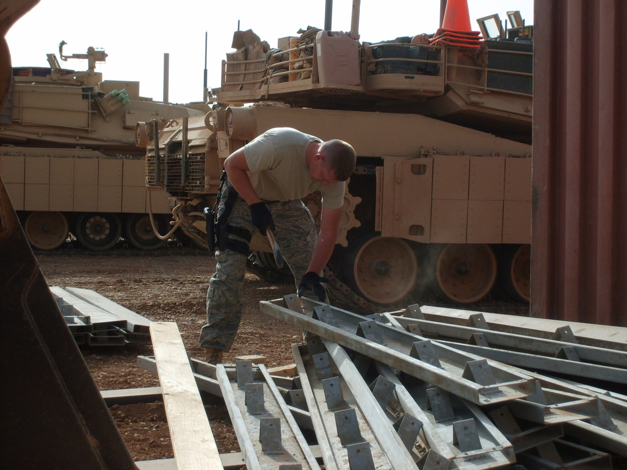 BALAD AIR BASE, Iraq -- Staff Sgt. Josh Jeffreys, 732nd Expeditionary Civil Engineer Squadron heavy operator, Dirt Boyz section, cleans concrete forms after a cement pouring project at Forward Operating Base Caldwell, Iraq. The concrete forms are used in the process of making pads for the Army motorpool Soldiers. These pads will allow Soldiers to perform maintenance on their vehicles without having to be in the dirt and mud. (U.S. Air Force photo/ Senior Airman Dan Smith)