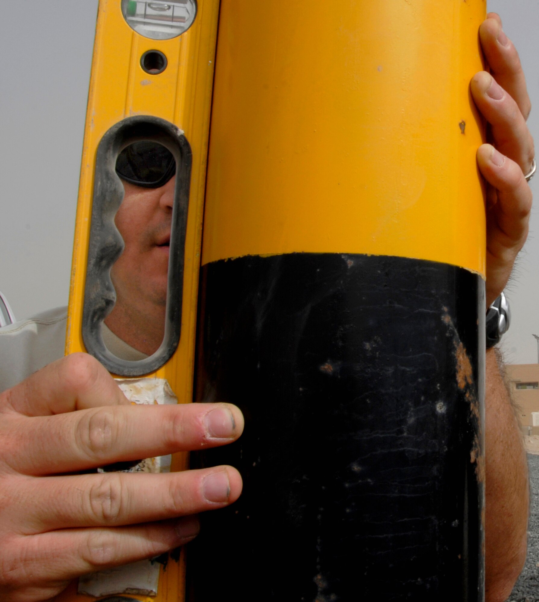 SOUTHWEST ASIA -- Technical Sgt. Dirk Mancuso, deployed to the 386th Expeditionary Civil Engineer Squadron, uses a level to check the position of a new traffic bollard May 21, 2008, at an air base in the Persian Gulf Region. Members from the 386th ECES are installing new traffic bollards to improve force protection on the air base. Sergeant Mancuso is deployed from the Louisiana Air National Guard’s 159th Fighter Wing in New Orleans. (U.S. Air Force photo/ Staff Sgt. Patrick Dixon) 