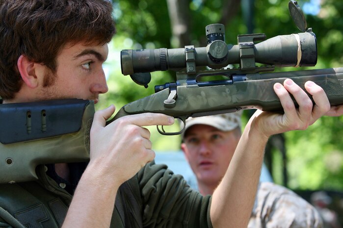 Noah Naples, 19, takes a close look at the M40A3 Sniper rifles as Cpl. Daniel Smith, a sniper school instructor with 2nd Marine Division explains how to site-in on a target. A Marine Day was held in Central Park, New York City, so that visitors could get a firsthand look at Marine Corps.