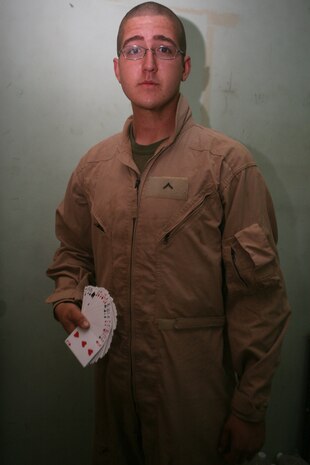 Pfc. Kyle D. Alders, a scout with Charlie Company, 2nd Light Armored Reconnaissance Battalion, Regimental Combat Team 5, fans a deck of playing cards at Camp Korean Village, Iraq, May 23. One of Aldersâ?? hobbies is card tricks.  The 19-year-old from West Palm Beach, Fla., helped create a device for the blind before he joined the Marine Corps. Because of his efforts, he was changed from a young man who scored near perfect on the Scholastic Aptitude Test into a successful inventor, all before his 16th birthday.