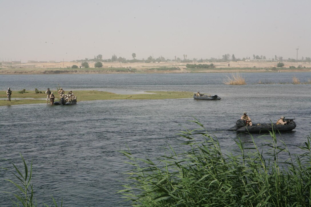 Marines aboard boats land on an island on the Euphrates River near Haditha, Iraq, May 25. Marines with Company L, 3rd Battalion, 4th Marine Regiment, Regimental Combat Team 5 swept islands in the river for any enemy contraband. They also swept the riverbanks in search of weapons. It was the first time Marines in the company worked with sailors with Riverine Squadron 3, Detachment 3, RCT-5.