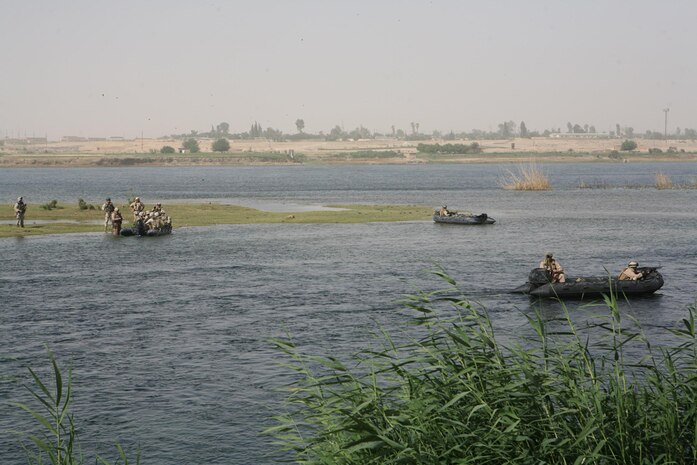 Marines aboard boats land on an island on the Euphrates River near Haditha, Iraq, May 25. Marines with Company L, 3rd Battalion, 4th Marine Regiment, Regimental Combat Team 5 swept islands in the river for any enemy contraband. They also swept the riverbanks in search of weapons. It was the first time Marines in the company worked with sailors with Riverine Squadron 3, Detachment 3, RCT-5.