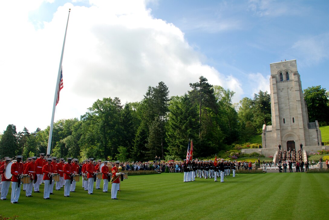 Marines from the Commandant's Own, United States Marine Corps Drum and Bugle Corps, Battle Color Detachment and the Silent Drill stand in position on the parade field at the Aisne-Marne American Cemetery and Memorial during a Memorial Day service May, 25.