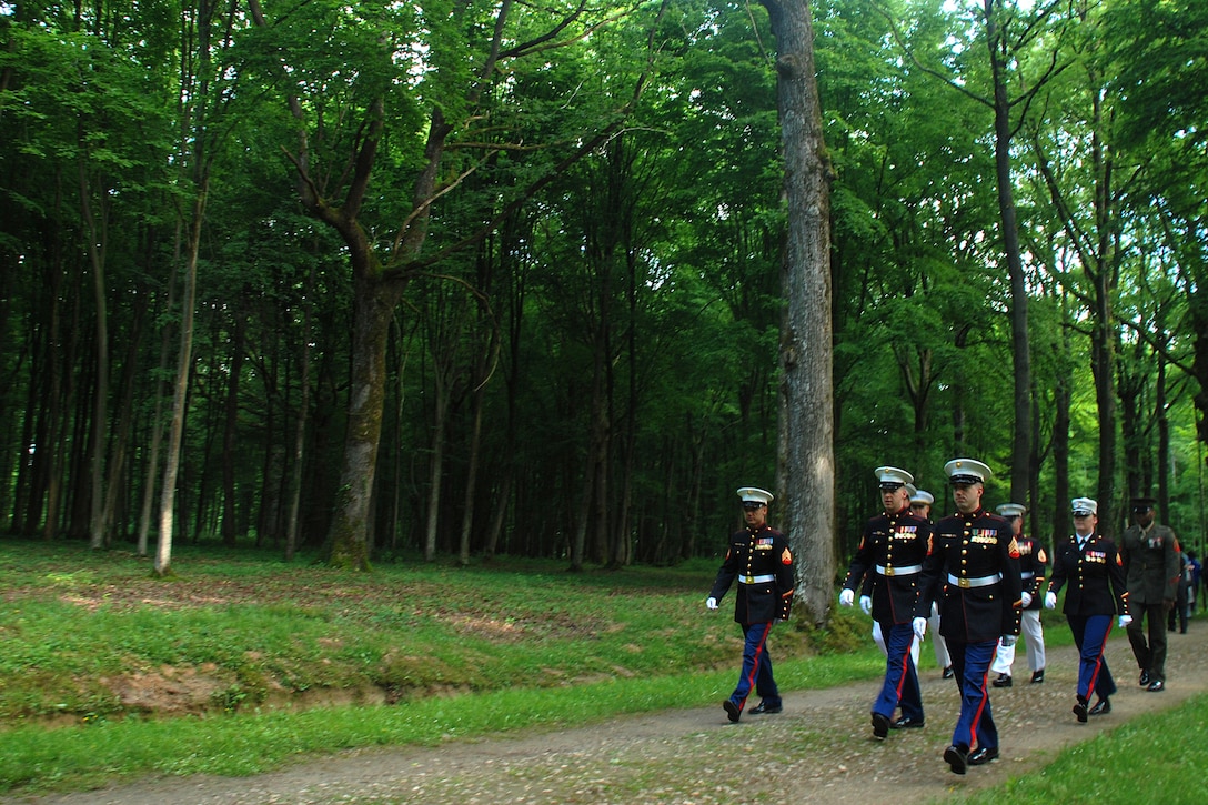 A group of Marines walk through Belleau Wood prior to the Memorial Day service here May 25. The Marines were joined by more than 4,000 visitors at the Aisne-Marne American Cemetery for a Memorial Day service.