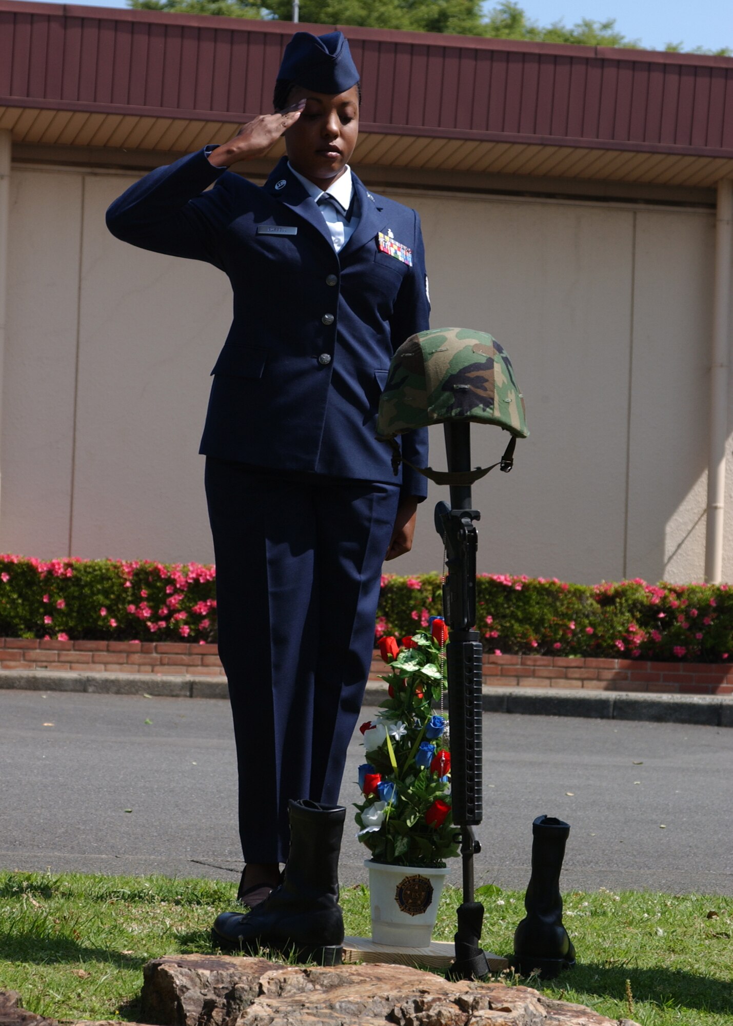 YOKOTA AIR BASE, Japan - Staff Sergeant Nicole Russell, from the 374th Dental Squadron, salutes a memorial for fallen soldiers during the American Legion's Memorial Day ceremony on May 26. The ceremony is held every in honor of those military members who have died serving. (U.S. Air Force photo by Airman 1st Class Jonathan Fowler)                               