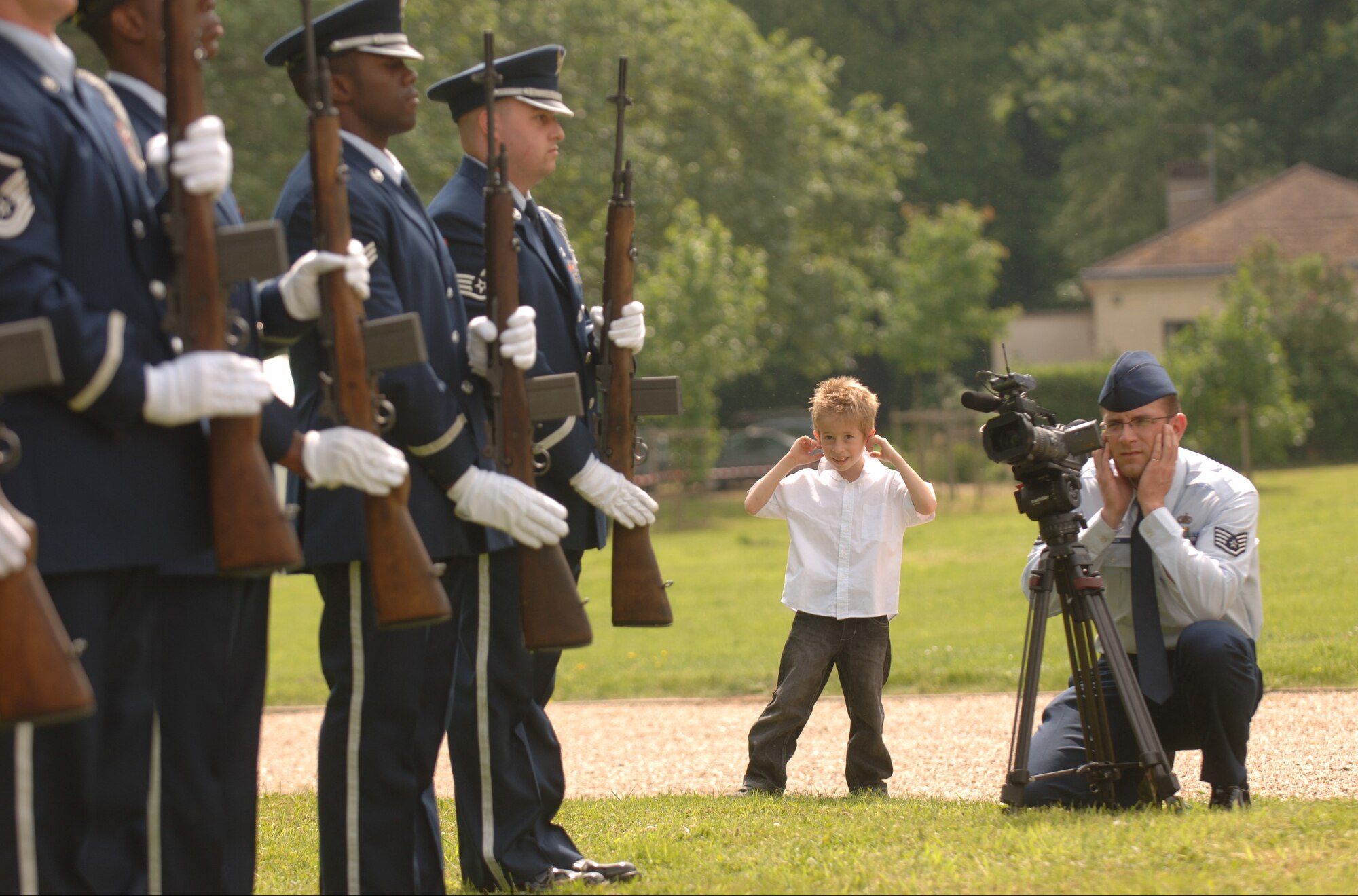 Staff Sgt. Dan Bellis, an Air Force News Agency television broadcaster, and a young French boy ready themselves for a rifle volley May 24 during a  memorial ceremony outside of Paris where French and American citizens paid homage to the United States' first combat aviators known as the Lafayette Escadrille. The all-American squadron of volunteers flew under the French flag during World War I. (U.S. Air Force photo/Master Sgt. Scott Wagers)