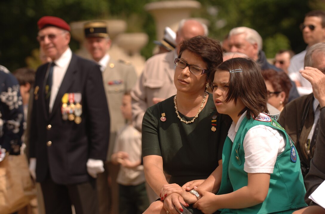 Dineen Angrisani and her 10-year-old daughter Celine Rivera observe the Lafayette Escadrille memorial ceremony outside of Paris May 24 where French and American citizens paid homage to an all-American squadron of volunteer pilots who flew under the French flag during World War I.  Ms. Angrisani is the committee chair for United States Girl Scouts Overseas. (U.S. Air Force photo/Master Sgt. Scott Wagers)