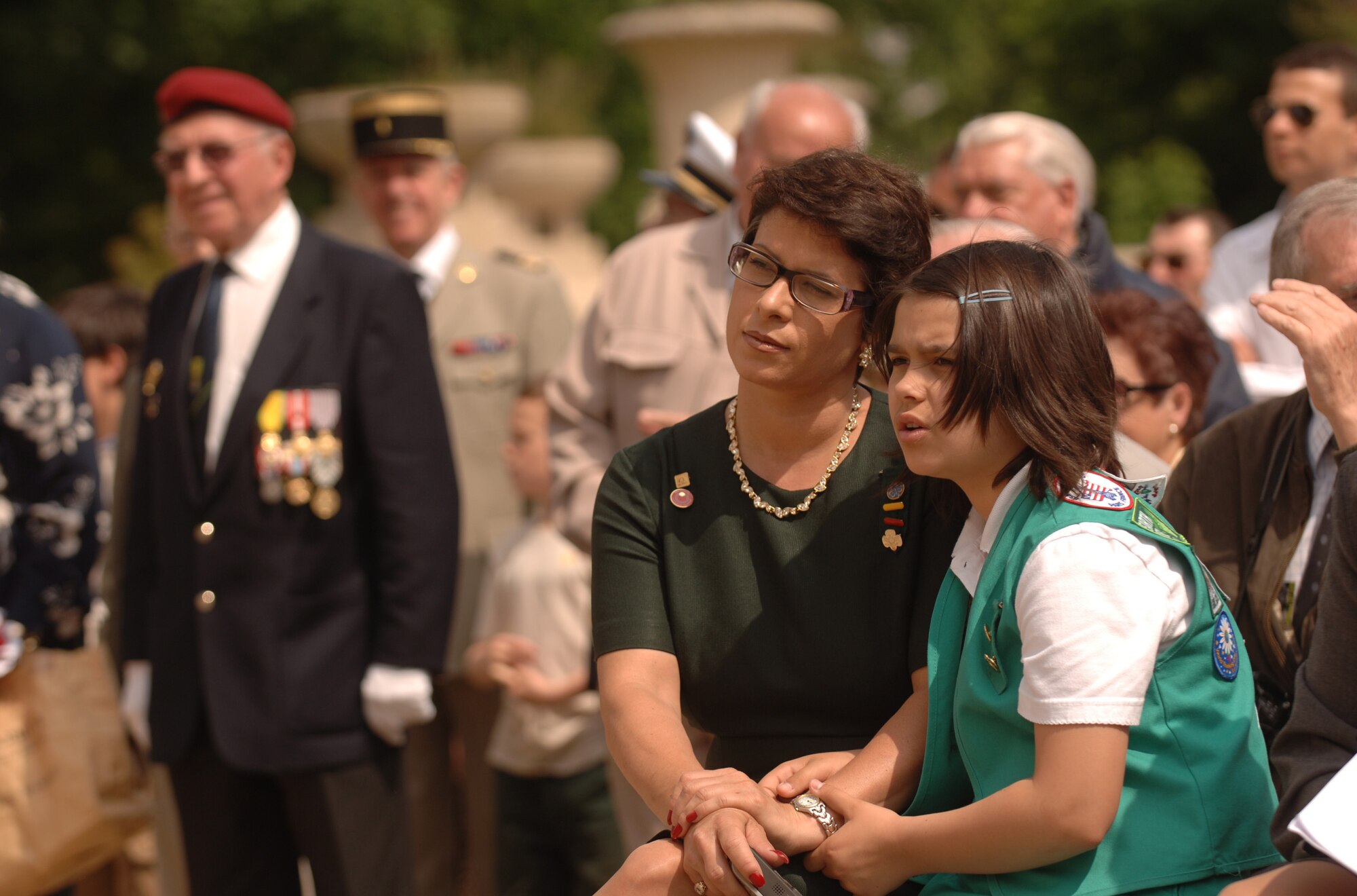 Dineen Angrisani and her 10-year-old daughter Celine Rivera observe the Lafayette Escadrille memorial ceremony outside of Paris May 24 where French and American citizens paid homage to an all-American squadron of volunteer pilots who flew under the French flag during World War I.  Ms. Angrisani is the committee chair for United States Girl Scouts Overseas. (U.S. Air Force photo/Master Sgt. Scott Wagers)