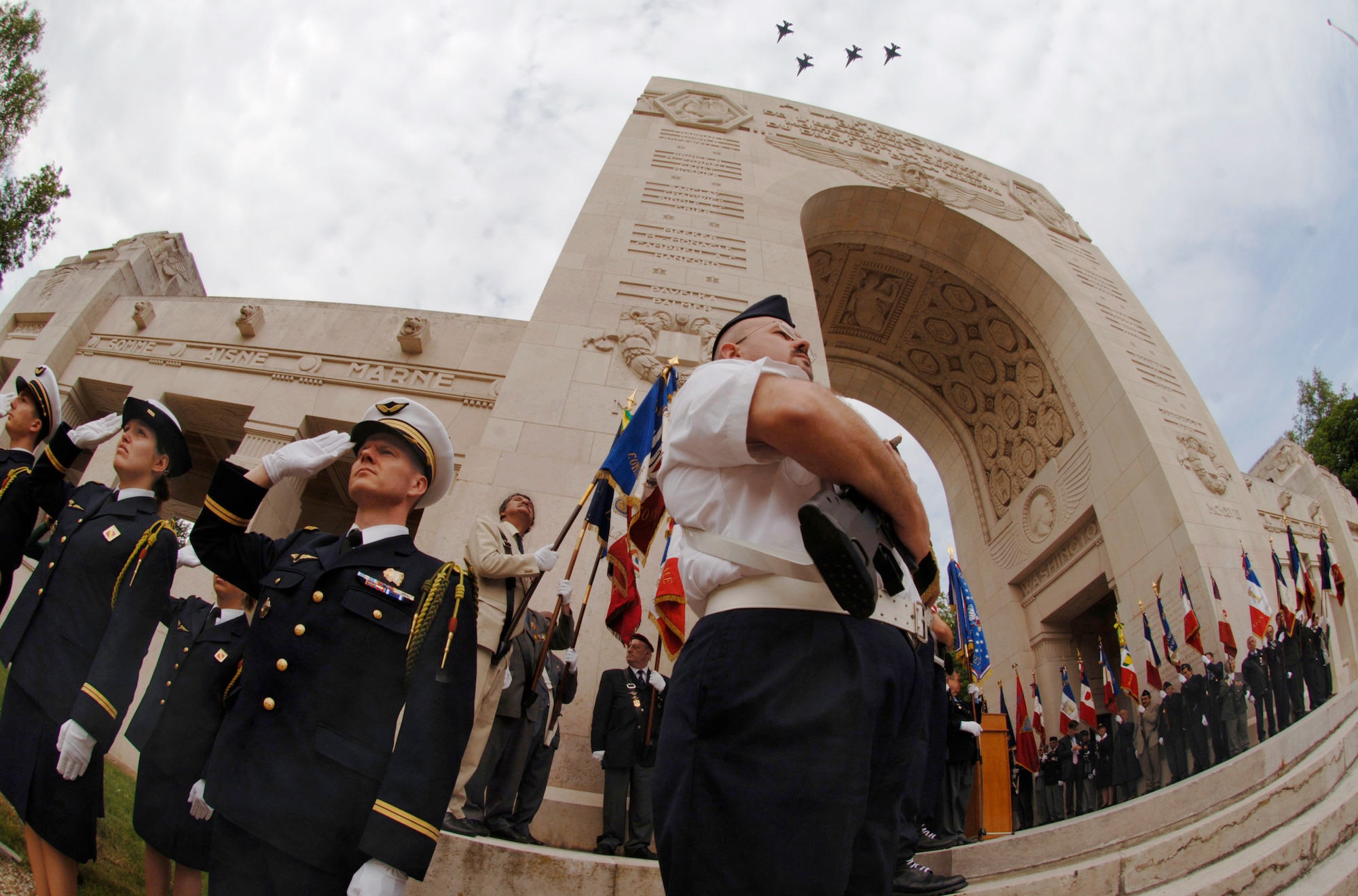 A formation of F-16 Fighting Falcons and French Mirages (not seen) punctuate a regal and colorful Lafayette Escadrille memorial ceremony outside of Paris May 24.  During the ceremony, French and American citizens paid homage to some of the United States' first combat aviators. The all-American squadron of volunteers flew under the French flag during World War I, and many gave their lives in defense of French democracy. The F-16s are from the 52nd Fighter Wing at Spangdahlem Air Base, Germany. (U.S. Air Force photo/Master Sgt. Scott Wagers)
