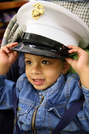 Two-year old Jake Mathews tries on a dress blues cover while visiting Marine Day in New York City's Time Square May 24.