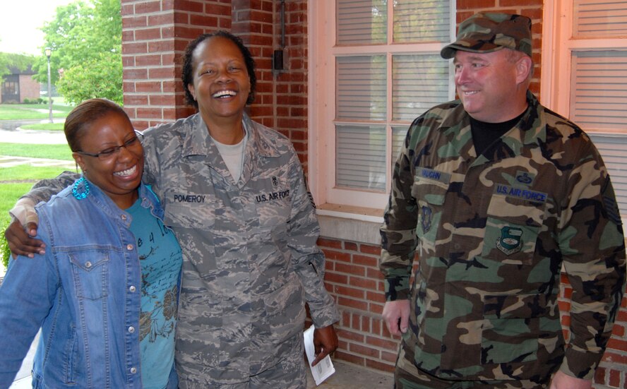 It is a bittersweet goodbye as Senior Master Sgt. Maryilyn Pomeroy laughs with family and friends in her unit before deploying on a trip overseas for the 932nd Airlift Wing, Air Force Reserve Command.  Photo/Maj. Stan Paregien