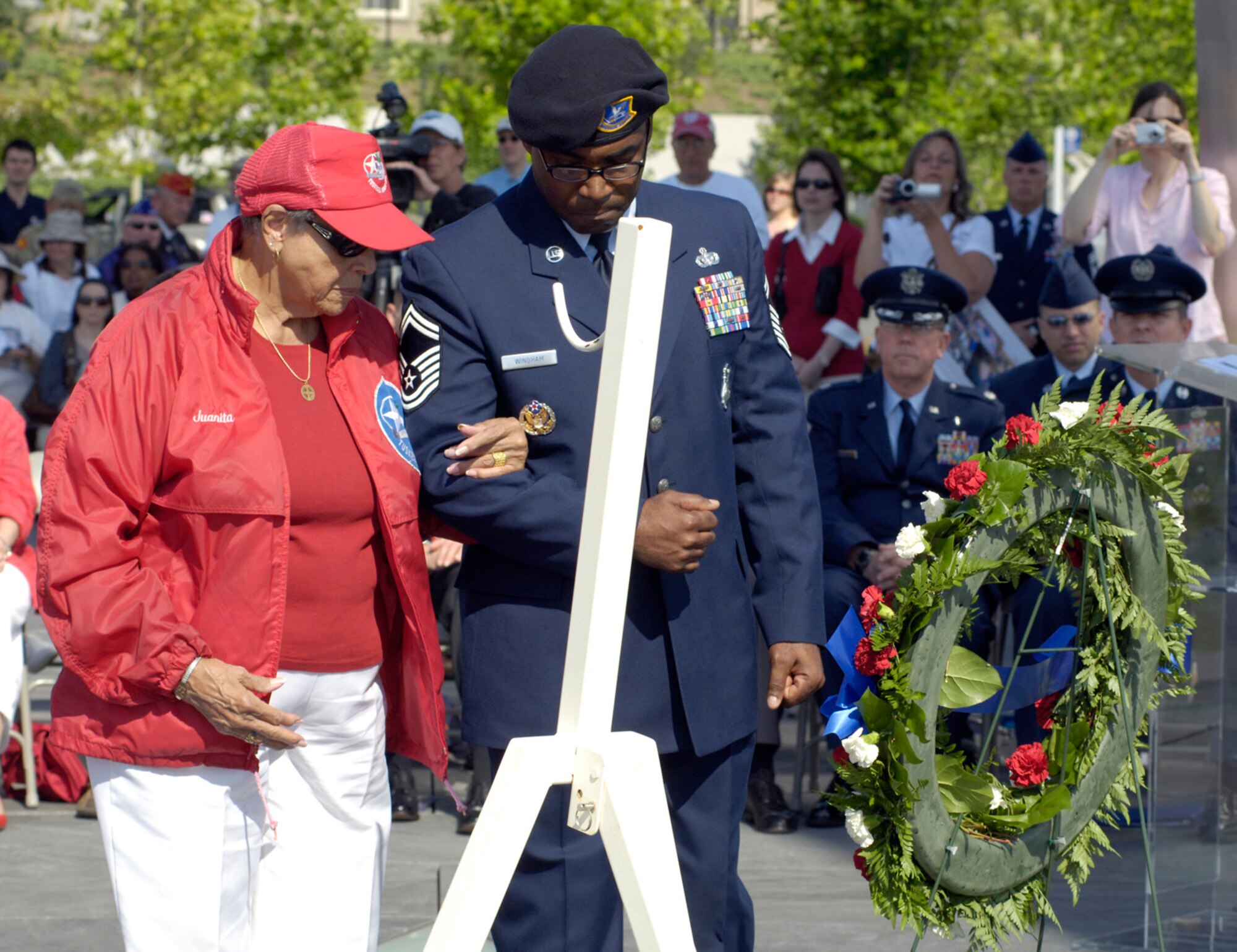 Ms. Juanita Harris is escorted by Senior Master Sergeant Eric Windham during a Memorial Day wreath-laying ceremony  at the Air Force Memorial, Washington, D.C., May 26, 2008. Ms. Harris placed a wreath in honor of her husband Stanley who was a fighter pilot for the Tuskegee Airmen during World War II. Sergeant Windham is stationed at the Pentagon in the Headquarters Air Force Special Security Office. The ceremony was co-sponsored by the Air Force Association and Air Force Sergeants Association. (U.S. Air Force photo by Master Sgt. Jim Varhegyi)

