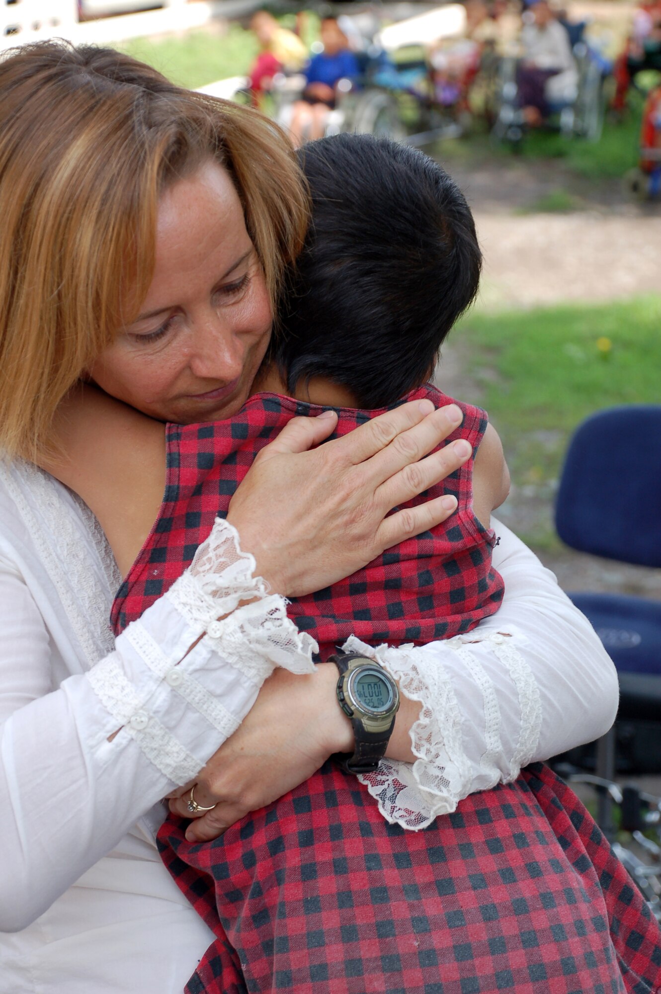 (08/05/25) MANAS AB, KYRGYZSTAN – Staff Sgt. Rebecca Packard, U.S. Air Forces Central Band Thunder Roll vocalist, takes a moment to say goodbye at the Belovodosky Orphanage.  The AFCENT band performed at the orphanage and explained the different instruments the band uses during their visit.  (U.S. Air Force/TSgt Jerome Baysmore/ Released)