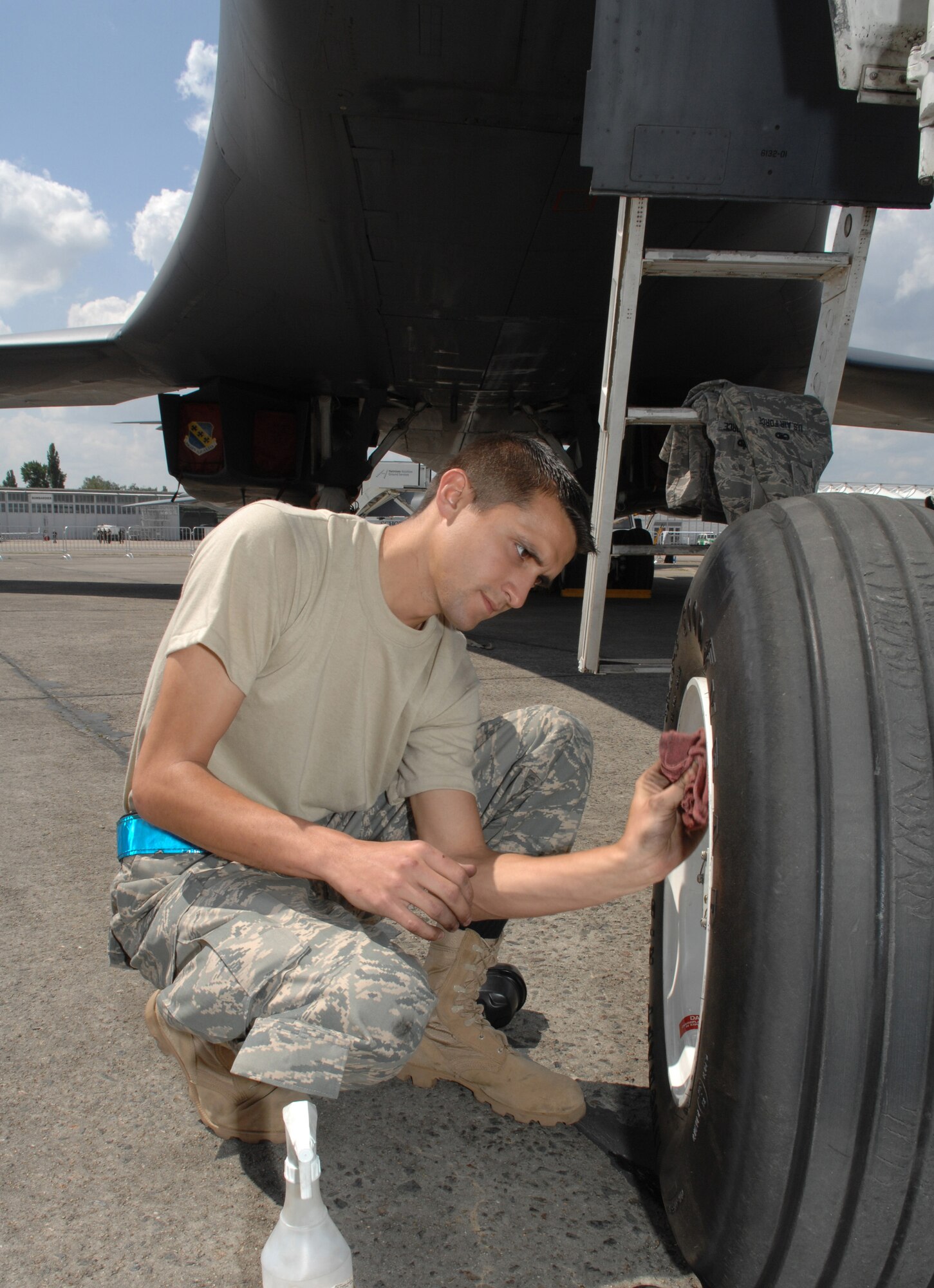 BERLIN, Germany - U.S. Air Force Senior Airman Marcus Smith cleans the nose landing gear of a B-1B Lancer bomber aircraft of the 7th Bomb Wing at Dyess Air Force Base, TX in preparation for the 2008 Berlin Air Show here May 24. SrA Smith is an aircraft maintenance crew chief of the 7th Aircraft Maintenance Squadron, 7th BW, on temporary duty for the first time away from his home station.  (U.S. Air Force photo by Tech. Sgt. Corey Clements)