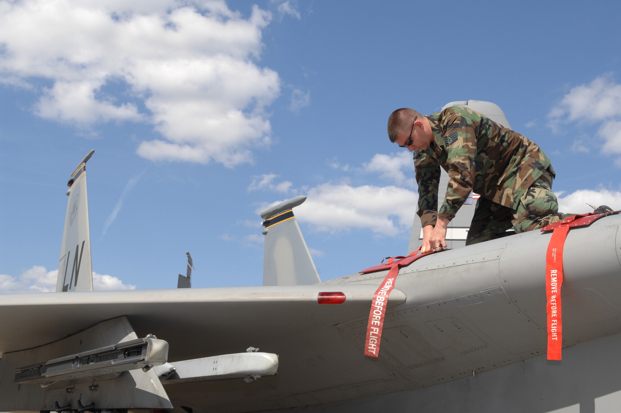 BERLIN, Germany - Staff Sgt. Russell Middleton, and aircraft electrical and environmental systems technician from the 493rd Fighter Squadron, installs the covers for gunloaders on an F-15C Eagle from the 48th Fighter Wing, Royal Air Force Lakenheath, UK here May 25 in preparation for the 2008 Berlin Air Show. U.S. participation in the Berlin Air Show enhances the U.S.-German military-to-military relationship and supports our security cooperation strategic direction efforts. (U.S. Air Force photo by Tech. Sgt. Corey Clements) (released)