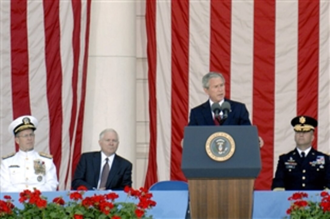 President Bush delivers a Memorial Day address in the Tomb of the Unknowns amphitheater at Arlington National Cemetery, Va., May 26, 2008. Seated behind the commander in chief are Navy Adm. Mike Mullen, left, chairman of the Joint Chiefs of Staff, Defense Secretary Robert M. Gates and Army Maj. Gen. Richard J. Rowe Jr., Military District of Washington commander.