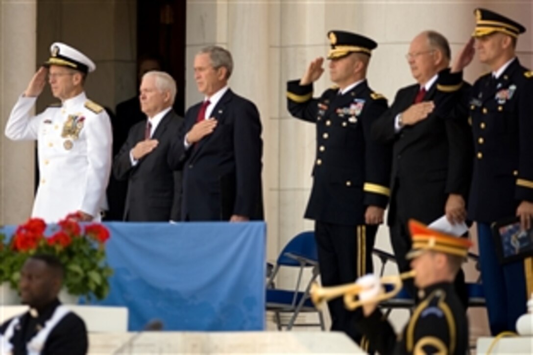From left: Navy Adm. Mike Mullen, chairman of the Joint Chiefs of Staff, Defense Secretary Robert M. Gates, President George W. Bush, Army Maj. Gen. Richard J. Rowe Jr., commanding general, Military District of Washington, Veterans Affairs Secretary James B. Peake and Army Col. David Moran, Military District of Washington chaplain, render honors during the playing of Taps at the conclusion of the Memorial Day wreath-laying ceremony at Arlington National Cemetery, Va., May 26, 2008.  