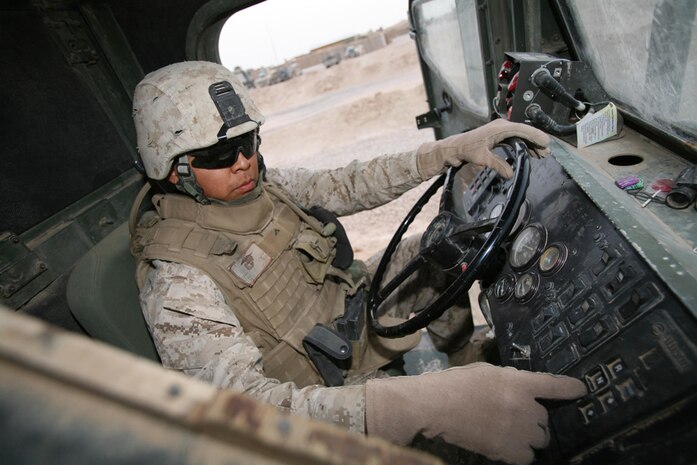 Lance Cpl. Brennan R. Beall, 22, an administrative clerk with 3rd Battalion, 4th Marine Regiment, Regimental Combat Team 5, from Many Farms, Ariz., prepares his seven-ton truck at Combat Outpost Haditha, Iraq, May 26. Beall has been serving as a machine gunner for Truck Platoon, 3rd Bn., 4th Marines during the battalionâ??s deployment to Iraq. He has also been used as a driver.  Marines with backgrounds in communication, administration and supply have been providing convoy security during re-supply missions.