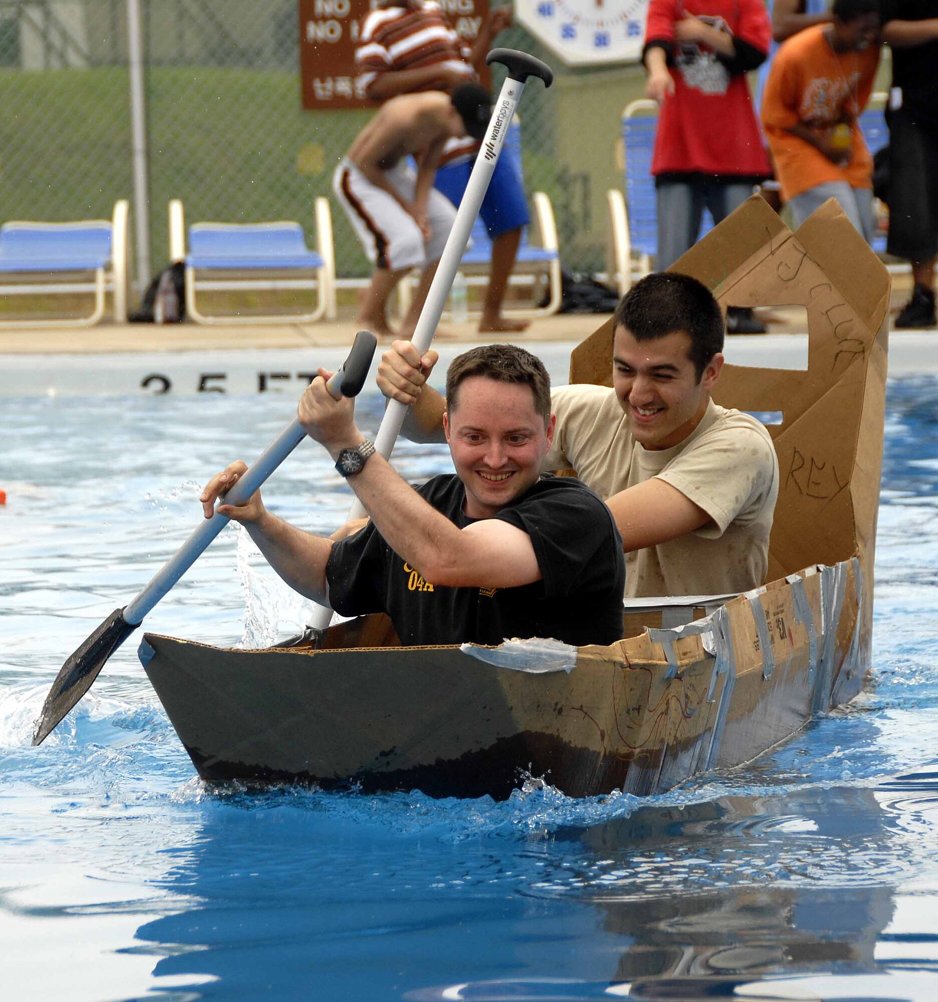 OSAN AIR BASE, Republic of Korea -- Staff Sgt. Erik Milton and Staff Sgt. Miguel Reynoso, 51st Medical Support Squadron biomedical equipment repair technicians, race towards the half way point of the build-a-boat contest before winning at the base’s outdoor pool May 23. The top three teams were awarded prizes. The contest was held in conjunction with the 51st Fighter Wing’s 101 Critical Days of Summer burger burn. (U.S. Air Force photo/Senior Airman Christopher Boitz)
