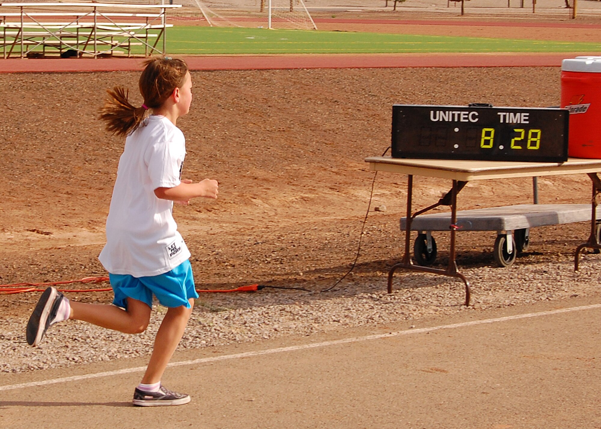 A child from Holloman Air Force Base, N.M., reaches the half way point for the two mile run during America's Kids Run at the base fitness center on May 17. The run is offered to kids living on Naval, Air Force, and Army bases around the world. (U.S. Air Force photo/Airman 1st Class Michael Means)