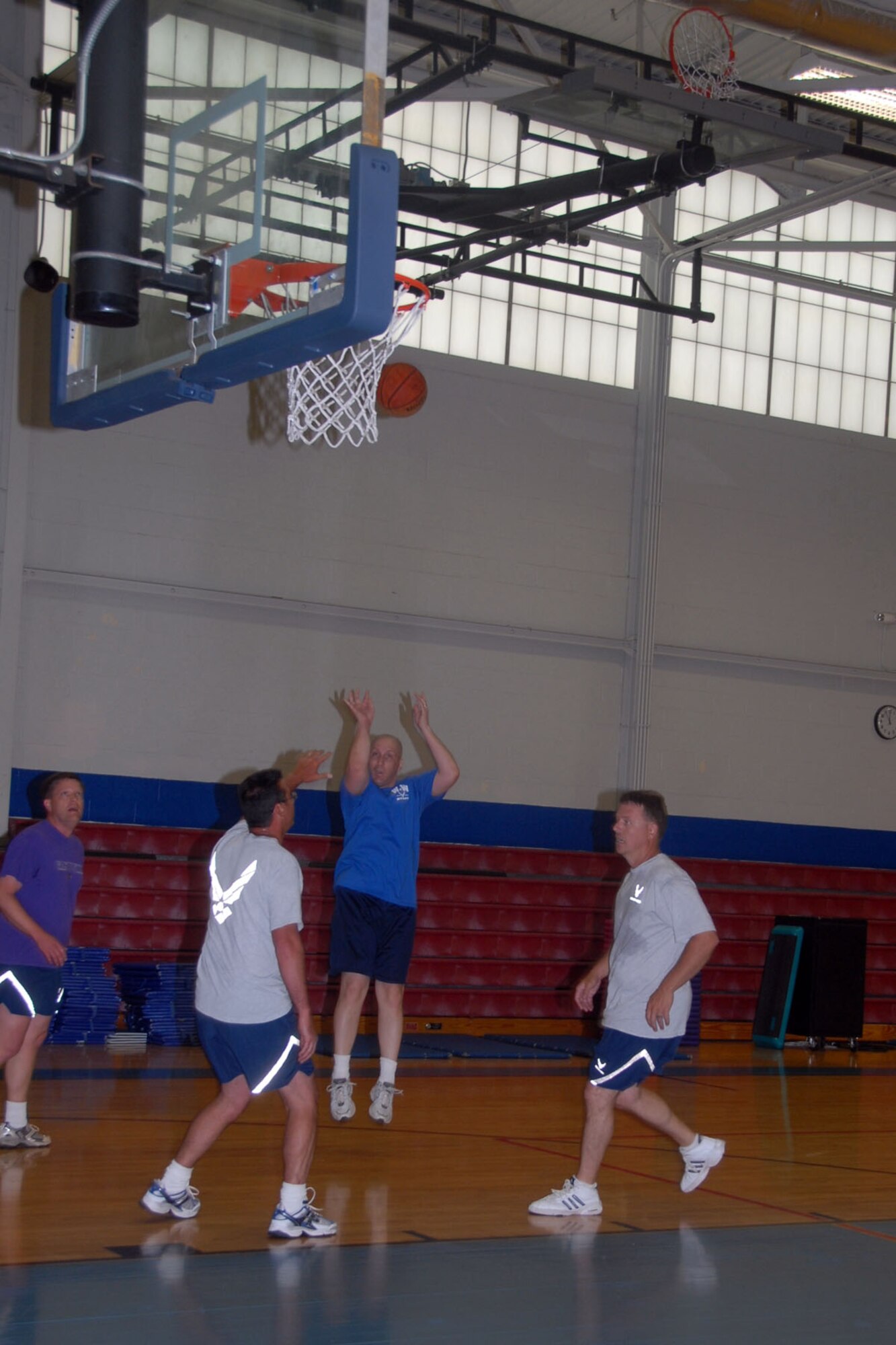 ALTUS AIR FORCE BASE, Okla. -- Col. David Allvin, 97th Air Mobility Wing commander, shoots over a defender during the Eagles (senior officers) vs. Chiefs Basketball Game at the Base Fitness and Sports Center May 23. The Eagles edged out Chiefs during three-on-three basketball, winning the first two games in a best of three tournament. The game is held each year to boost wing morale and highlight the cohesive team between officers and enlisted (U.S. Air Force photo/Airman 1st Class Cherice Bryant)