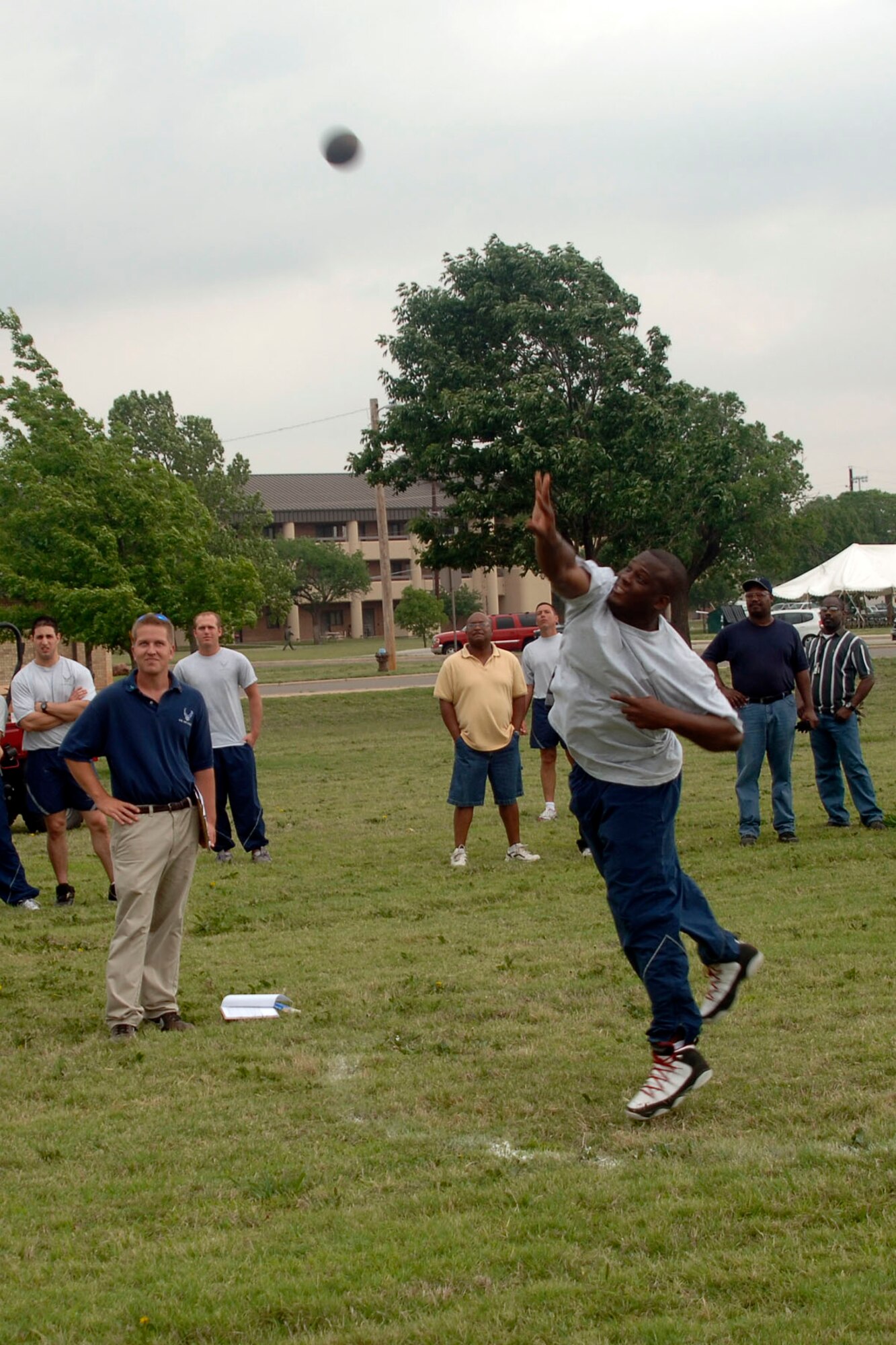 ALTUS AIR FORCE BASE, Okla. -- Senior Airman Lavatra Thomas, 97th Comptroller Squadron, launches a shot during Shot Put event at Altus AFB's first Sports Day at the Base Parade Grounds May 23. Airman Thomas threw the shot 45 feet for a won first place finish. (U.S. Air Force photo/Senior Airman Clinton Atkins)