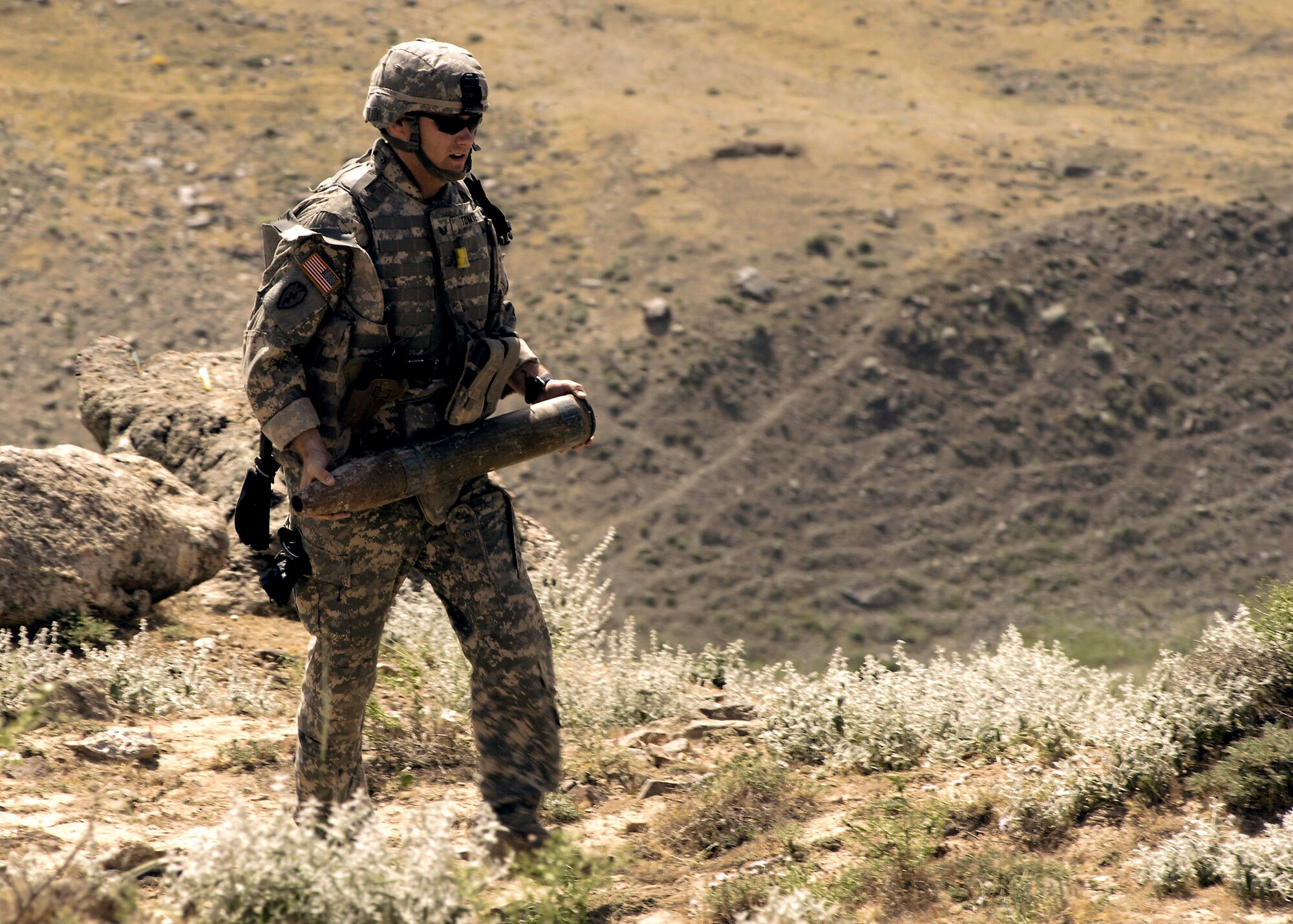 Tech. Sgt. Jay Tomten transports a rocket to a safe disposal area for detonation after a local farmer alerted authorities when he found two 107mm rockets. Sergeant Tomten is deployed as an 755th Air Expeditionary Group Explosive Ordnance Disposal team leader. (U.S. Air Force photo/Master Sgt. Demetrius Lester)