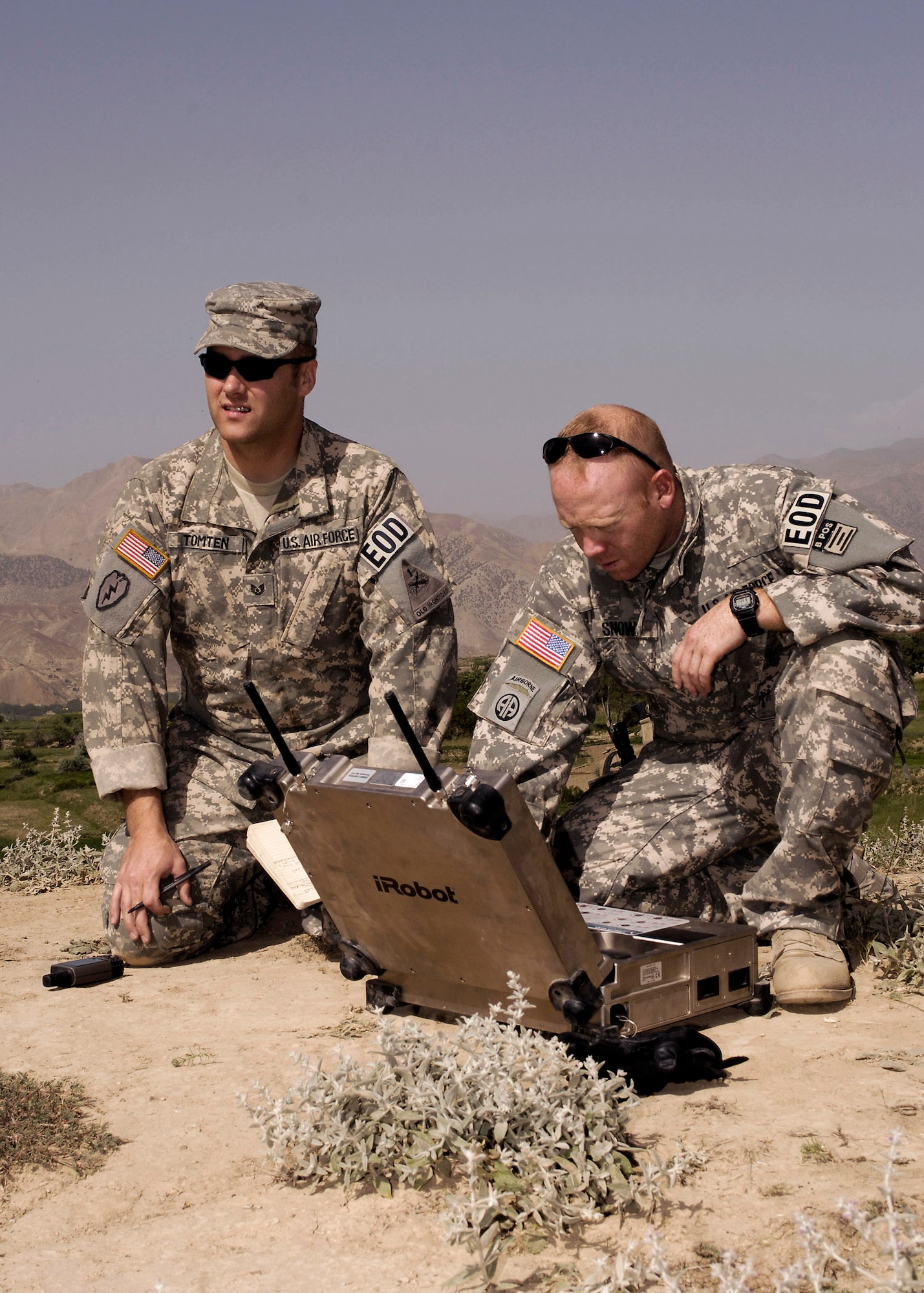 Tech. Sgt. Jay Tomten (left) 755th Air Expeditionary Group Explosive Ordinance Disposal team leader and Staff Sgt. Jason Snow 755th Air Expeditionary Group robot operator prepare to send a PACBOT to a incident site. Two 107mm rockets on a timer were found to be aimed at a coalition FOB that was found by a local farmer who contacted authorities. Sergeant Tomten is deployed from the 49th Civil Engineer Squadron EOD flight Holloman Air Force Base N.M. and Sergeant Snow is deployed from the 1st CES EOD flight Langley AFB, Va. (U.S. Air Force photo/Master Sgt. Demetrius Lester)