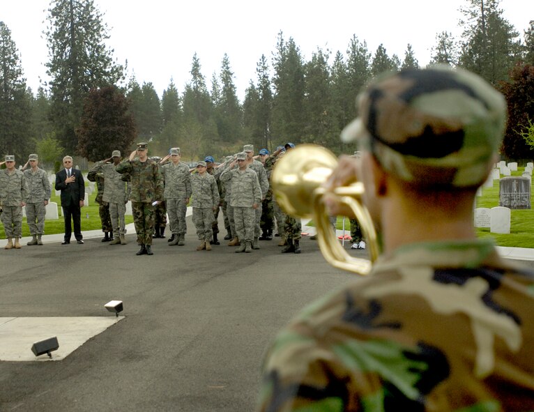 Spokane, Wash.  – Members of the 92nd Logistics Readiness Squadron salute the flag while taps is played during a memorial service at Ft. Wright cemetery in here May 22. (U.S. Air Force photo / Staff Sgt. Chad Watkins) 