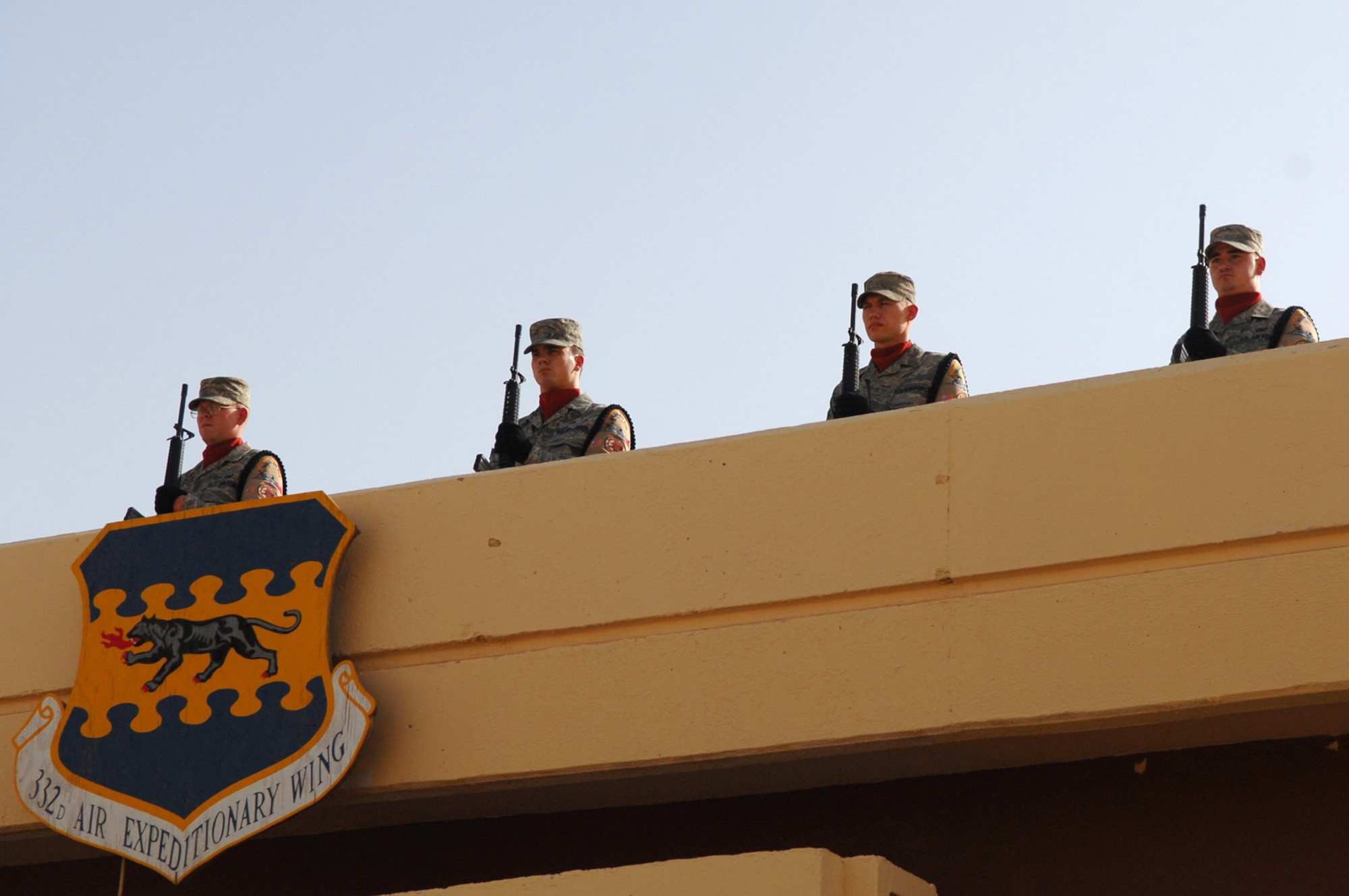Airmen from the Balad Honor Guard stand at attention during a Memorial Day ceremony at Balad Air Base, Iraq, May 26. During the ceremony, the names of 44 Airmen assigned to the 332nd Air Expeditionary Wing who have died since 2003 were read. Honor Guard Airmen conducted a 21-gun salute to honor their deceased comrades and played Taps. The U.S. flag was flown at half-staff until noon on Memorial Day. (U.S. Air Force photo/Senior Airman Julianne Showalter)