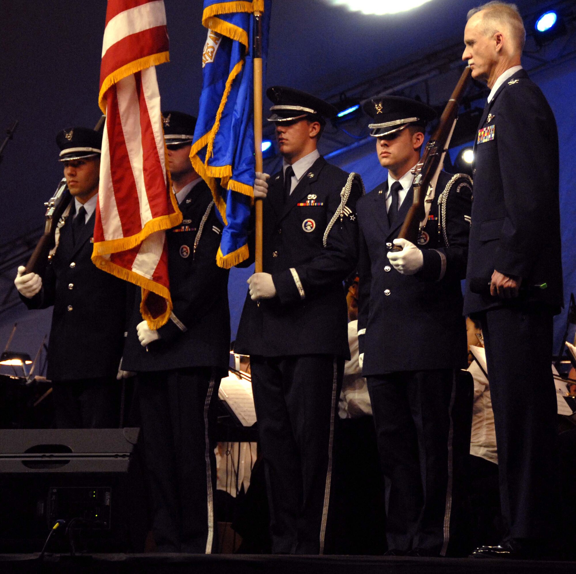 Col. Robert S. Arthur, 442nd Fighter Wing commander, stands at attention with the Whiteman Air Force Base Honor Guard while the Kansas City Symphony plays the Air Force Song to observe Memorial Day, May 25, 2008.  The members of the honor guard are, left to right, Airman 1st Class Gregory Diaz, Airman 1st Class Jonathan Leonard, Senior Airman Andrew Hammes and Airman 1st Class Brian Lowes.  Colonel Arthur was the military master of ceremonies for the annual "Celebration at the Station" observance produced by the Kansas City Symphony at Union Station and the World War I Liberty Memorial in downtown Kansas City.  The evening's events included patriotic music performed by the symphony, as well as ceremonies honoring all members of the U.S. armed forces in front of more than 40,000 spectators.  The 442nd Fighter Wing is an Air Force Reserve A-10 Thunderbolt II-unit based at Whiteman. (U.S. Air Force photo/Maj. David Kurle)