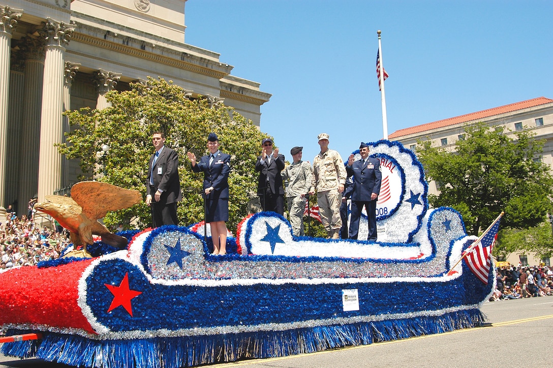 Special Agent (Master Sgt.) Jac Christiansen (far right), Air Force Office of Special Investigations, Detachment 406, Columbus Air Force Base, Miss., and Senior Airman Mary Bullock (second from left), 11th Intelligence Squadron, Hurlburt Field, Fla., were handpicked by Air Force leadership to be Grand Marshals in this year's parade because of their heroic acts or outstanding work in support of OPERATIONS IRAQI FREEDOM or ENDURING FREEDOM. Also aboard the lead float was actor and Grand Marshal Gary Sinise (center). (Air Force photo/Tech. Sgt. John Jung)