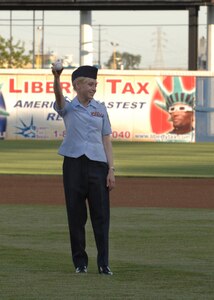 LANGLEY AIR FORCE BASE, Va. -- Master Sgt. Tracy King, 1st Medical Group, waves to the crowd May 22 at Harbor Park in Norfolk, Va., home of the Norfolk Tides Baseball team. The Tides host an annual military appreciation night where they invite representatives from each branch to throw an opening pitch. Sergeant King was selected to throw the first pitch of the game.  (U.S. Air Force photo/Airman Rebecca Montez) 