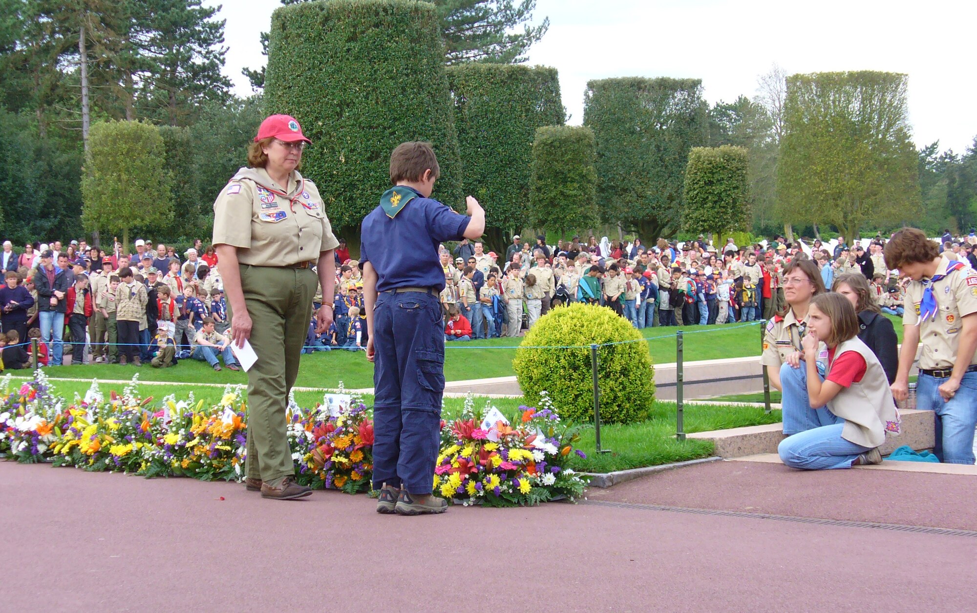 Cub Scout Garrett Blenkush, 7, pays his respects to fallen U.S. servicemembers in Normandy, France, recently. Garrett and his brother Severin Blenkush III, 10, together with more than 3,600 scouts, descended on the beachhead and surrounding area April 25-27 for a beach cleaning service project followed by a memorial service on Omaha Beach. The scouts are sons to Lt. Col. Severin Blenkush, commander, Detachment 1, 21st Contracting Squadron. (Courtesy photo)