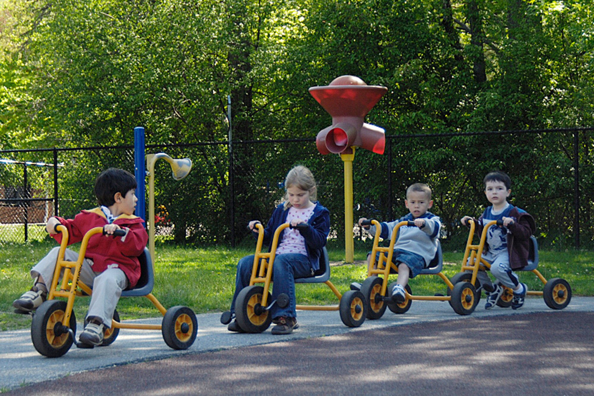 HANSCOM AFB, Mass. – Children enrolled in Hanscom’s Part-Day and Pre-School programs took part in a Trike-A-Thon May 20 to 22 at the Child Development Center. Pictured from left to right Kaito Dowland, Tiana Rodgers, Maximus Woolums and Nicholas Calfee ride their bikes around the CDC track on May 21. The Trike-A-Thon is held annually to teach children the importance of bike safety while also raising money for St. Jude’s Children’s Research Hospital.  (U.S. Air Force photo by Linda LaBonte Britt)