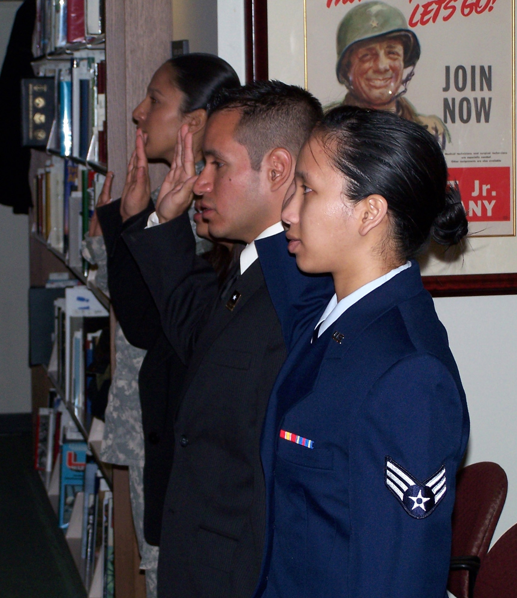 Senior Airman Katherine Collantes takes the Oath of Allegiance during the U.S. Citizenship and Immigration Services Naturalization Ceremony at the Pritzker Military Library in Chicago. Airman Collantes is assigned to the 434th Air Refueling Wing, Grissom Air Reserve Base, Ind. Brig. Gen. Darren McDew, director of public affairs, Office of the Secretary of the Air Force, was the keynote speaker. (U.S. Air Force photo)